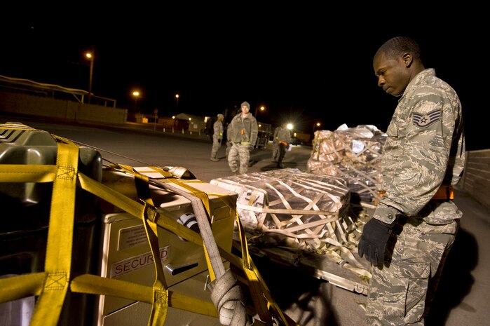 U.S. Air Force Staff. Sgt. Darnell Roberts, 99th Force Support Squadron services specialist, ensures all cargo straps are secured prior to loading an aircraft during an operational readiness exercise March 19, 2012, at Nellis Air Force Base, Nev. The exercise tests the wing's capability to deploy personnel and equipment to perform their mission at forward deployed locations worldwide. (U.S. Air Force photo by Airman 1st Class Daniel Hughes)