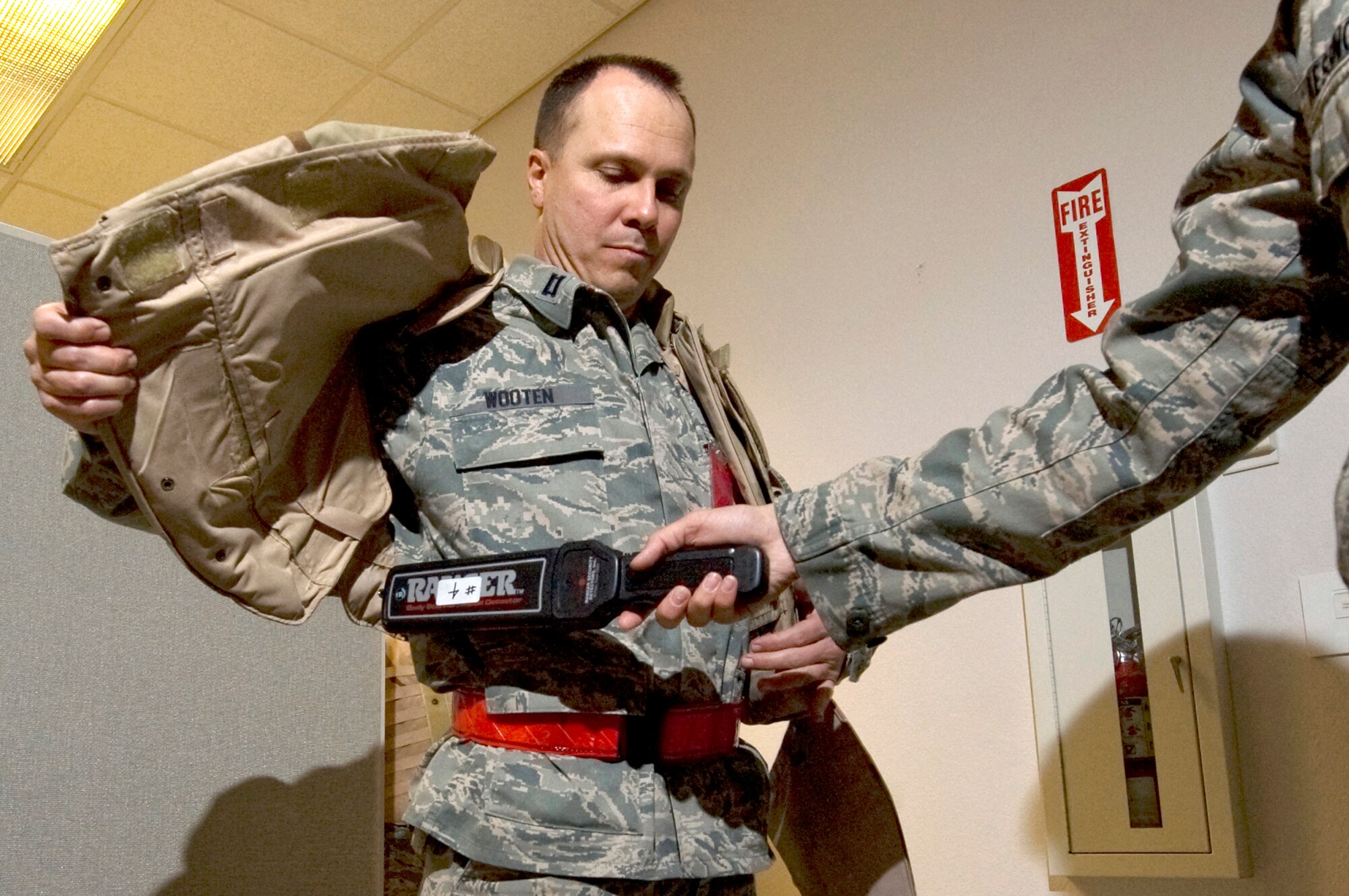 U.S. Air Force Capt. David Wooten, 99th Medical Group bioenvironmental officer, is scanned for unauthorized items during the 99th Air Base Wing's operational readiness exercise March 19, 2012, at Nellis Air Force Base, Nev. The exercise involved airmen across the 99th Air Base Wing from all occupational specialties, and included intensive training activities designed to hone mobilization skills. (U.S. Air Force photo by Airman 1st Class Daniel Hughes)