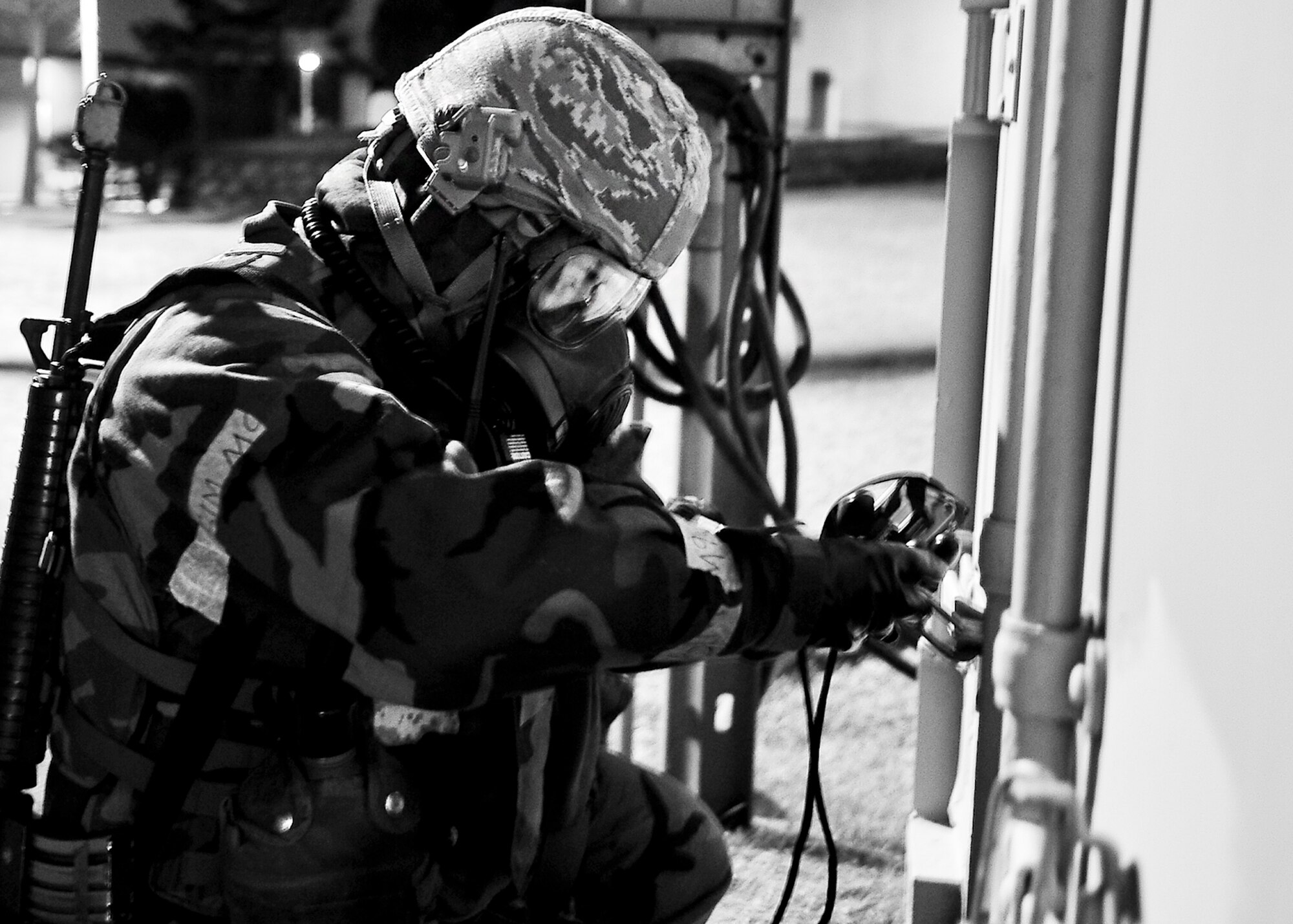 Senior Airman Angel Logan, 51st Civil Engineer Squadron emergency management technician, checks the lock on a conex box March 19, 2012, during exercise Beverly-Midnight 12-01. Exercises such as this test Osan's ability to survive and operate during war while also testing the ability to plan and execute an exercise. (U.S. Air Force photo/Senior Airman Adam Grant)