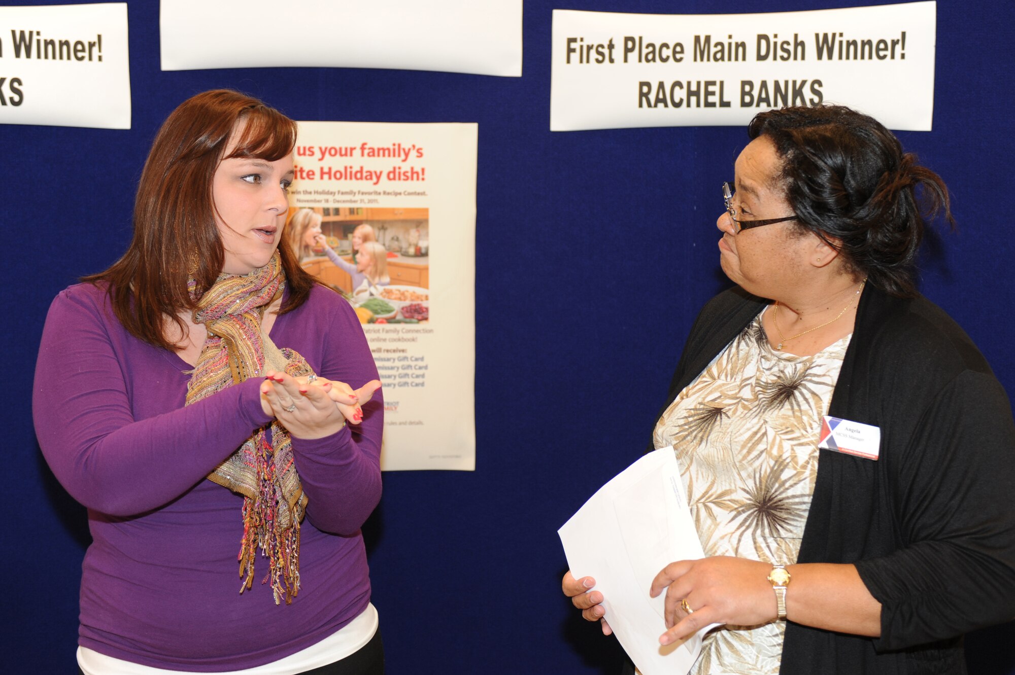 Rachel Banks, left, explains the preparation of her “Chicken Thingys” dish to Angela Spruill in the Exchange at Seymour Johnson Air Force Base, N.C., March 14, 2012. The award winning dish is chicken rolled in a crescent roll with cream cheese and chives, topped with stuffing, and placed first in the Holiday Family Favorite Contest. Banks, wife of Senior Airman Joshua Banks, 916th Air Refueling Wing command post controller, is from Charlotte, N.C. Spruill, Exchange military clothing manager, is from Jamesville, N.C. (U.S. Air Force photo/Airman 1st Class John Nieves Camacho/Released)
