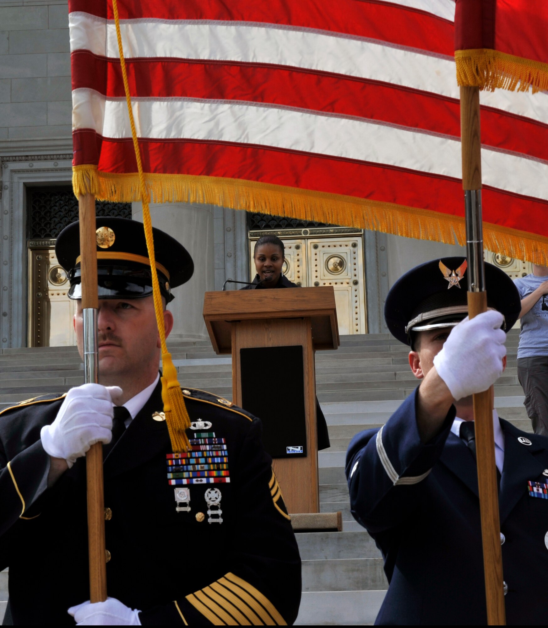 Tech. Sgt. Roxanne Weldon, 19th Communications Squadron non-commissioned officer in charge of base knowledge operations management, sings the National Anthem as the color guard posts the colors during the Arkansas Run for the Fallen in Little Rock, Ark., March 18, 2012. The run stared in Ozark, Ark., and finished at the state capitol. (U.S. Air Force photo by Airman 1st Class Rusty Frank)