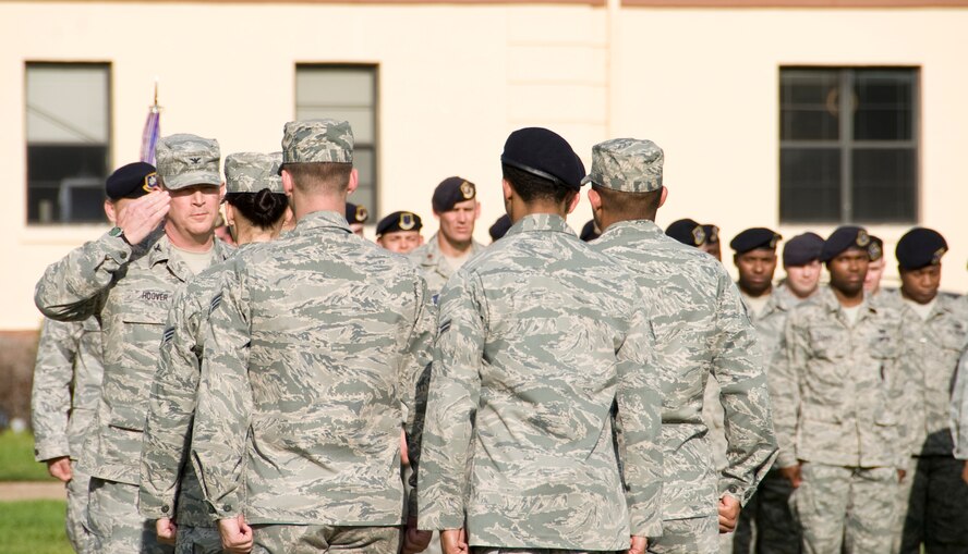 Col. Scott Hoover, 2nd Mission Support Group commander, returns a salute to the flag detail lead from the Barksdale Honor Guard during a retreat ceremony here, March 14. The senior member of the flag detail will salute and report to the commander to inform him the flag is secured. (U.S. Air Force photo/Airman 1st Class Benjamin Gonsier)(RELEASED)