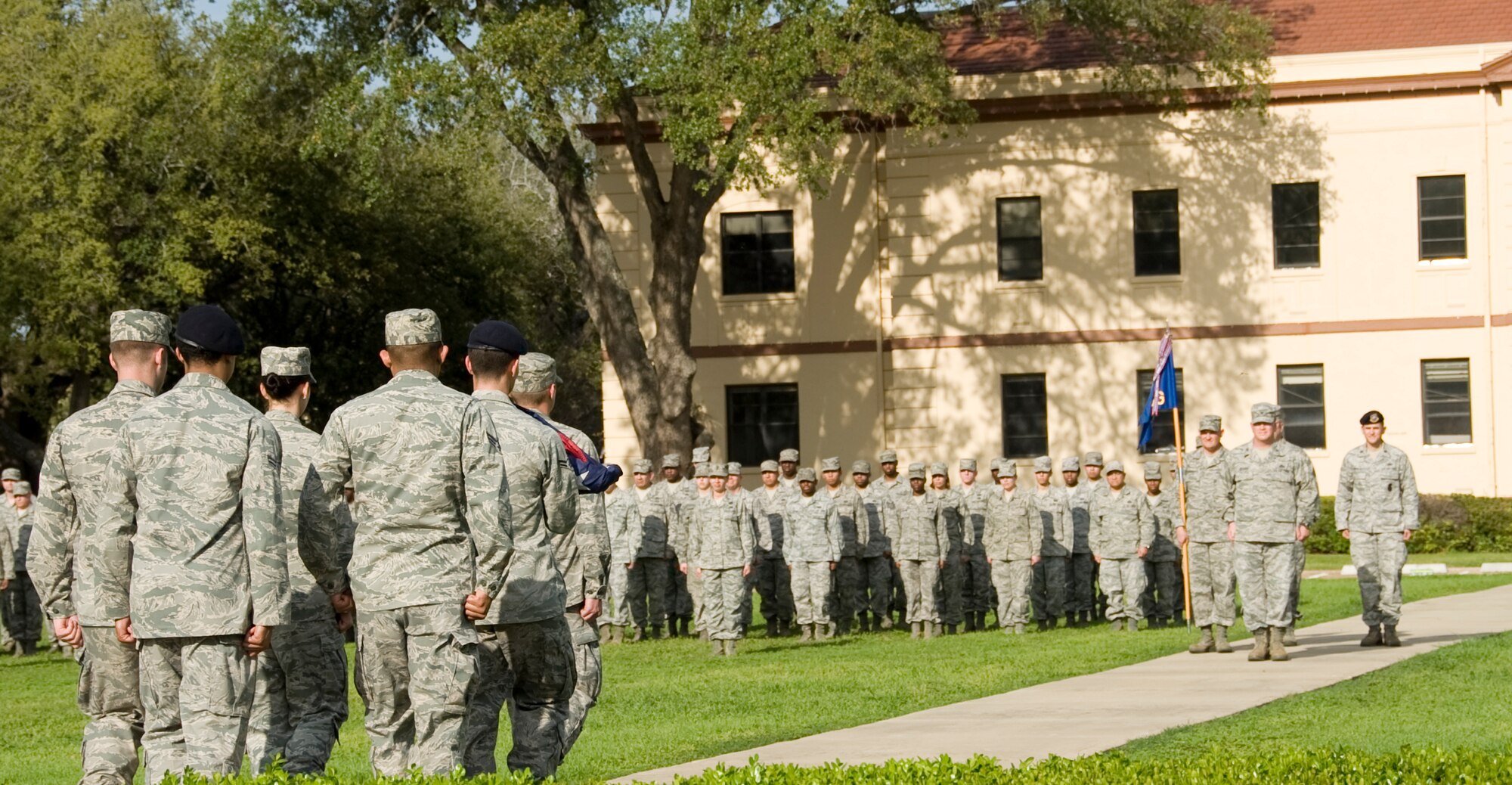 Airmen from the Barksdale Honor Guard march toward Col. Scott Hoover, 2nd Mission Support Group commander, during a retreat ceremony here, March 14. After the flag is folded, the flag detail reports to the commander. (U.S. Air Force photo/Airman 1st Class Benjamin Gonsier)(RELEASED)
