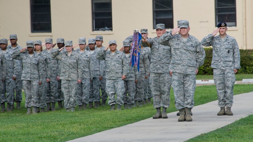 Col. Scott Hoover, 2nd Mission Support Group commander, and Airmen from the 2 MSG salute during a retreat ceremony on Barksdale Air Force Base, La., March 14. When "Retreat" starts to play, Airmen are to face the flag and stand at parade rest. Once the song concludes, the "National Anthem" will start to play and all Airmen must immediately come to attention and salute the flag. (U.S. Air Force photo/Airman 1st Class Benjamin Gonsier)(RELEASED)