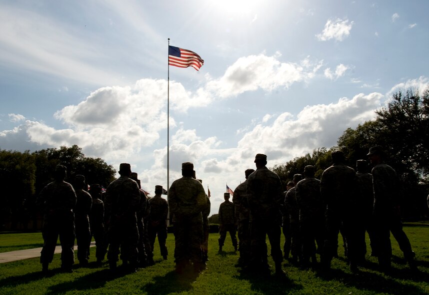 The American flag waves above Airmen from the 2nd Mission Support Group on Barksdale Air Force Base, La., March 14. The 2 MSG participated in a group-wide retreat ceremony to pay respect to the flag as an organization. (U.S. Air Force photo/Airman 1st Class Benjamin Gonsier)(RELEASED)