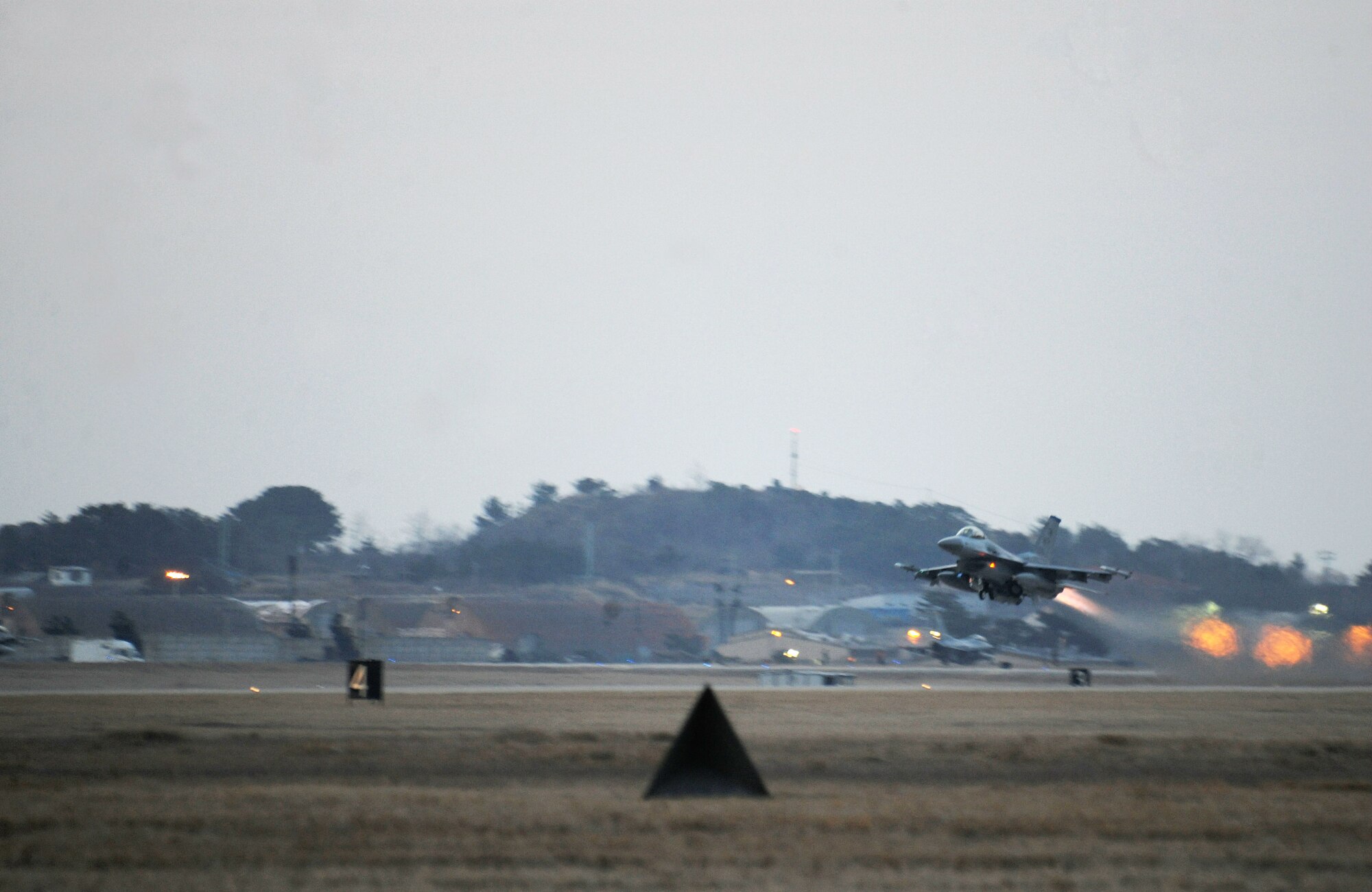 An F-16 Fighting Falcon from 8th Fighter Wing lifts off from the runway during an Operation operational readiness exercise at Kunsan Air Base, Republic of Korea, March 20, 2012. Exercises help ensure the skills and capabilities of operators, maintainers and supporting agencies of the Wolf Pack can operate effectively and safely in wartime conditions. (U.S. Air Force photo by Staff Sgt. Rasheen A. Douglas/Released)