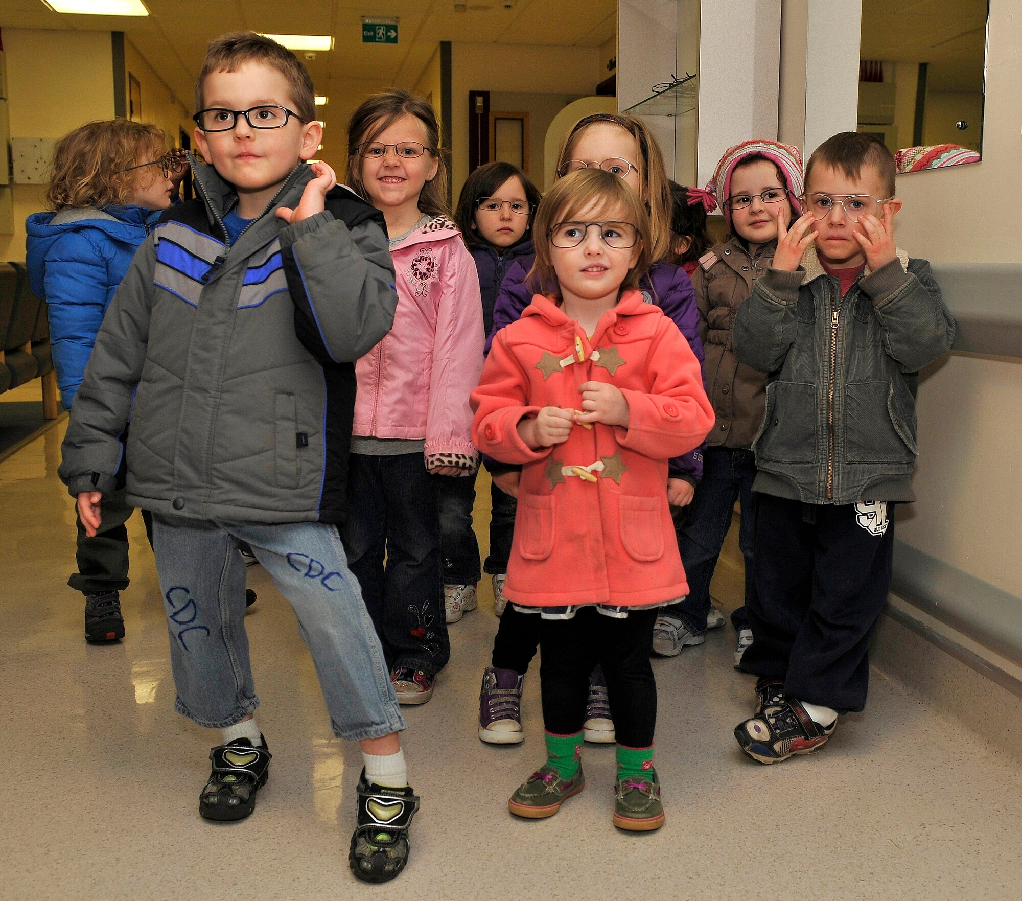 ROYAL AIR FORCE LAKENHEATH, England -- Children from Child Development Center West put on different eyeglasses during a visit to the optometry section at the RAF Lakenheath Hospital March 16, 2012.  The children toured the radiology and optometry departments to learn more about the human body and were given the opportunity to see and use various medical equipment. (U.S. Air Force photo by Staff Sgt. Connor Estes)