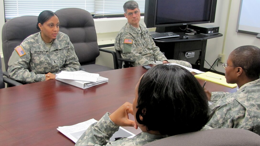 : U.S. Army Capt. Lynette R. Byars, center, Warrior Transition Unit executive officer, briefs leadership about relevant details for the WTU. As doctors, firefighters and more, women continue to serve a vital role in America’s armed forces. (U.S. Army photo by Marlon J. Martin/Released)