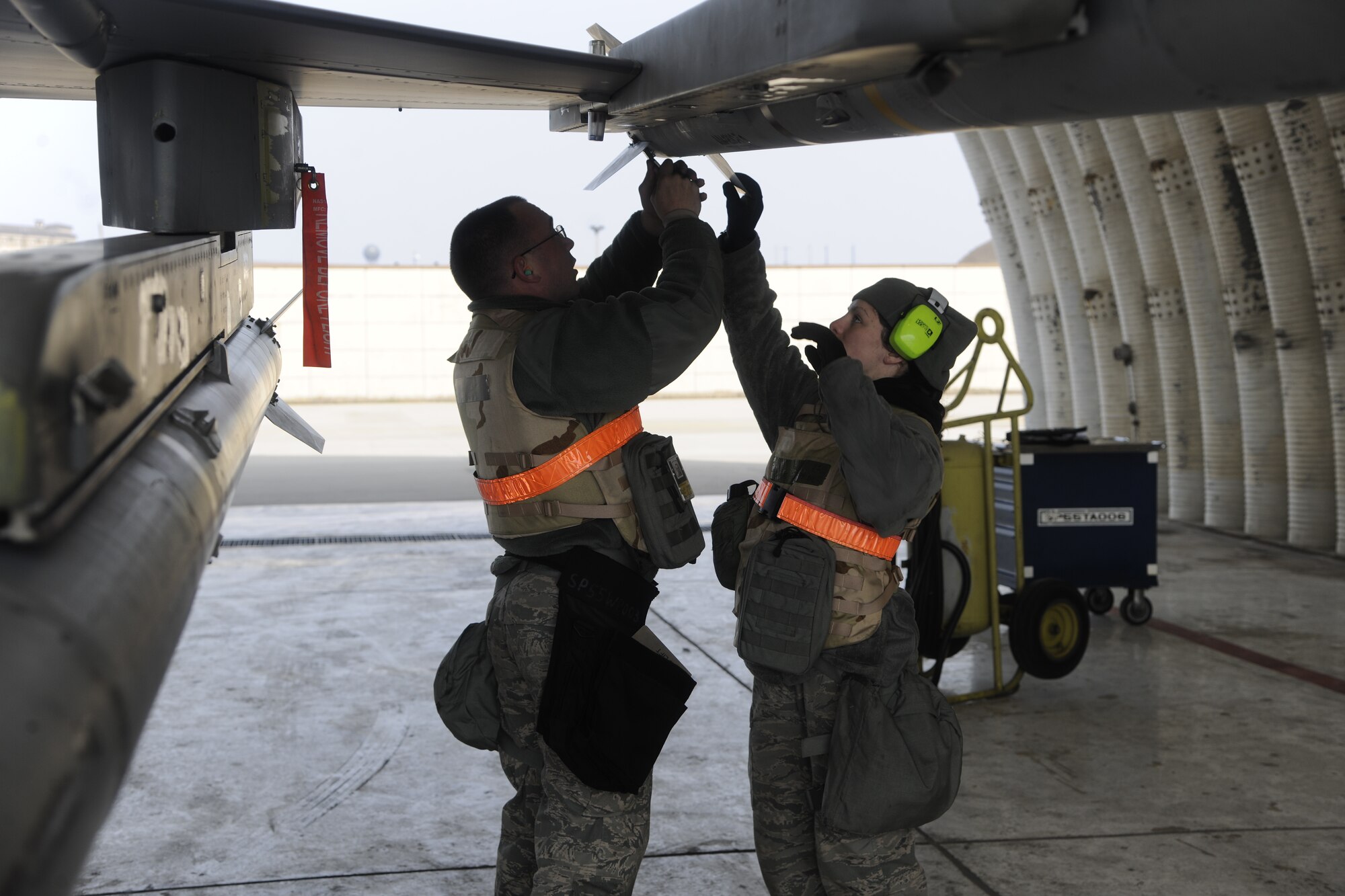 Airmen from the 20th Expeditionary Aircraft Maintenance Squadron, deployed from Shaw Air Force Base, S.C., to South Korea, take off fins from a missile after practicing loading them on an F-16 Fighting Falcon during an operational readiness exercise at Kunsan Air Base, Republic of Korea, March 19, 2012. Base exercises help ensure Wolf Pack Airmen are capable of performing their duties in wartime conditions. (U.S. Air Force photo by Staff Sgt. Rasheen A. Douglas/Released)