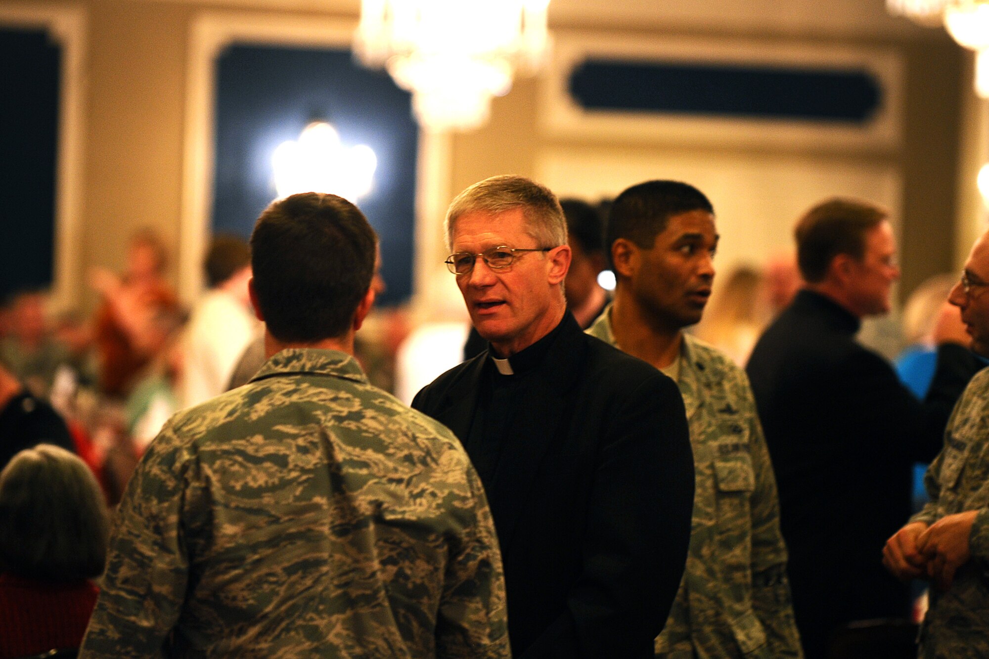 Father David Reeson, a priest of the Archdiocese of Omaha and retired Air Force chaplain, meets with members of the 55th Wing while attending the National Prayer Luncheon at the Patriot Club on Offutt Air Force Base, Neb., March 15.  The luncheon was hosted by Offutt's chaplain corps and featured guest speaker U.S. Air Force Chaplain (Maj. Gen.) Cecil R. Richardson. (U.S. Air Force photo by Josh Plueger/Released).