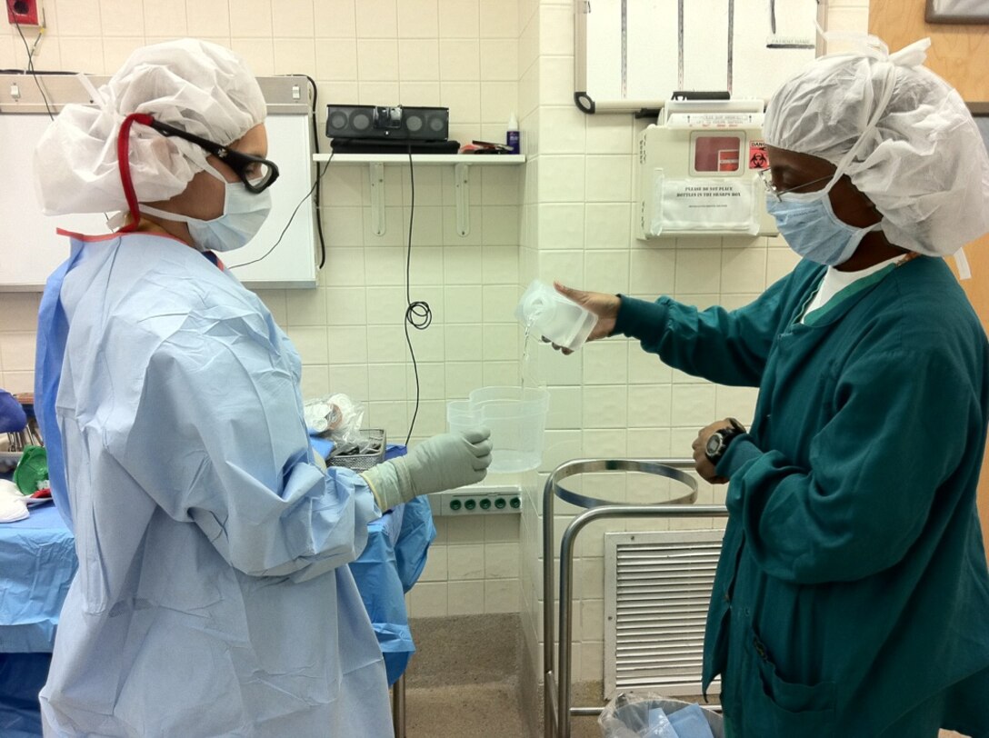 U.S. Army Spec. Jacqueline M. Lopez, left, and Maj. Vondalyn Simmons, prepare for a procedure at the McDonald Army Health Center at Fort Eustis, Va.  Mar. 19, 2012. As doctors, firefighters and more, women continue to serve a vital role in America’s armed forces. (Courtesy photo)