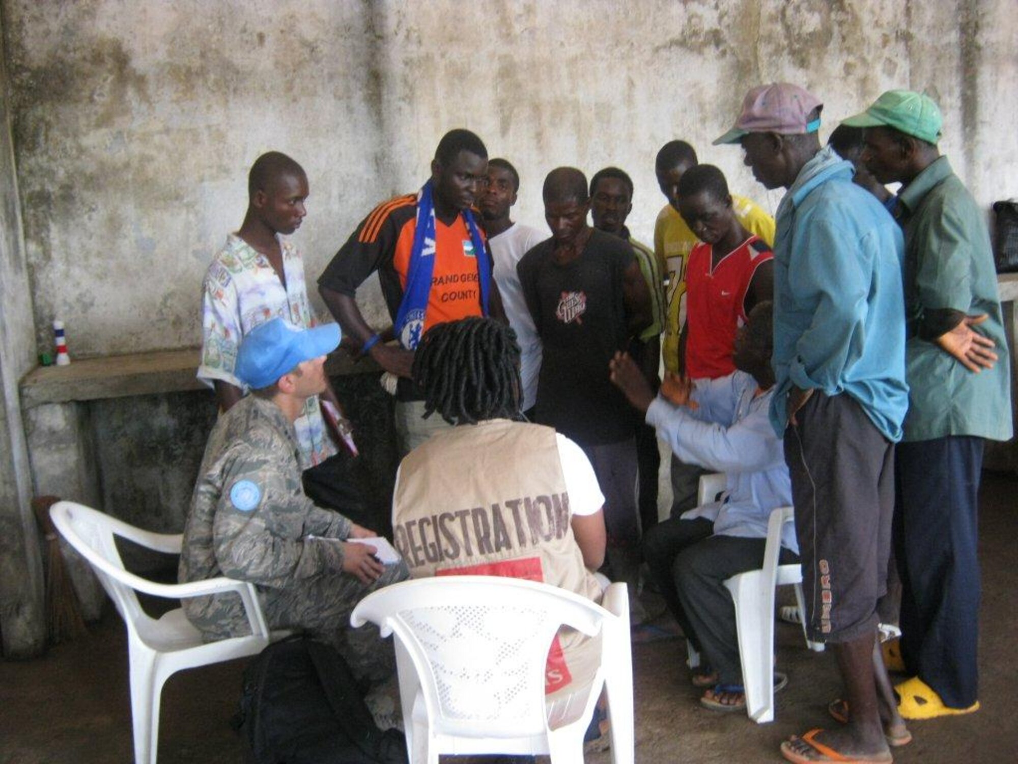 Capt. Paul Hrad, Air Force Research Laboratory aerospace engineer (left), meets with the refugee chairman at Solo Refugee Camp in Liberia, to discuss the presence of Ivory Coast military generals and mercenaries within the population.  (Ethiopian Air Force/ Maj. Fasile Ali Gupta)