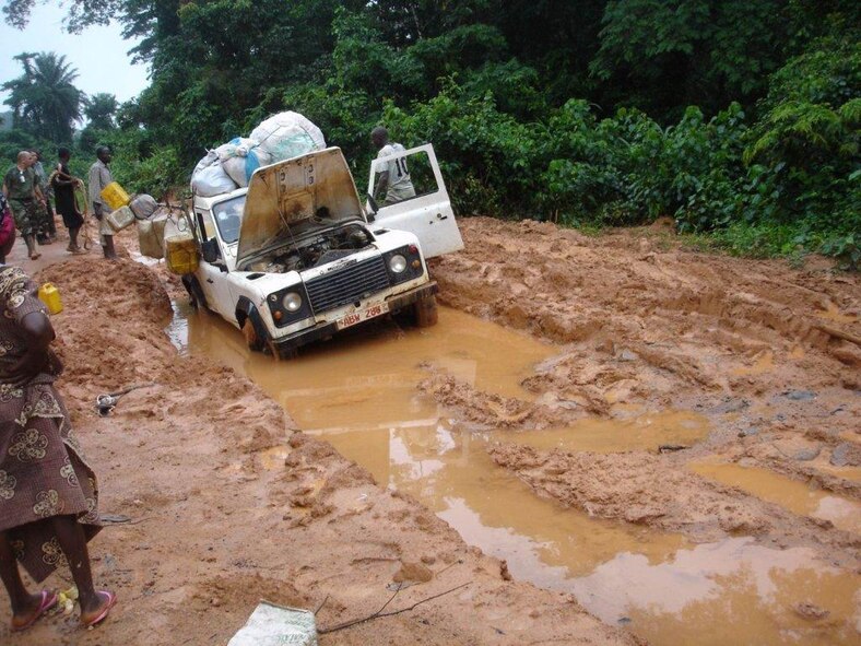 Capt. Hrad’s team assists with a stuck vehicle during this typical rainy season scene.  Liberian roads are poorly maintained, and rain often creates tremendous obstacles.  (United Nation courtesy photo)