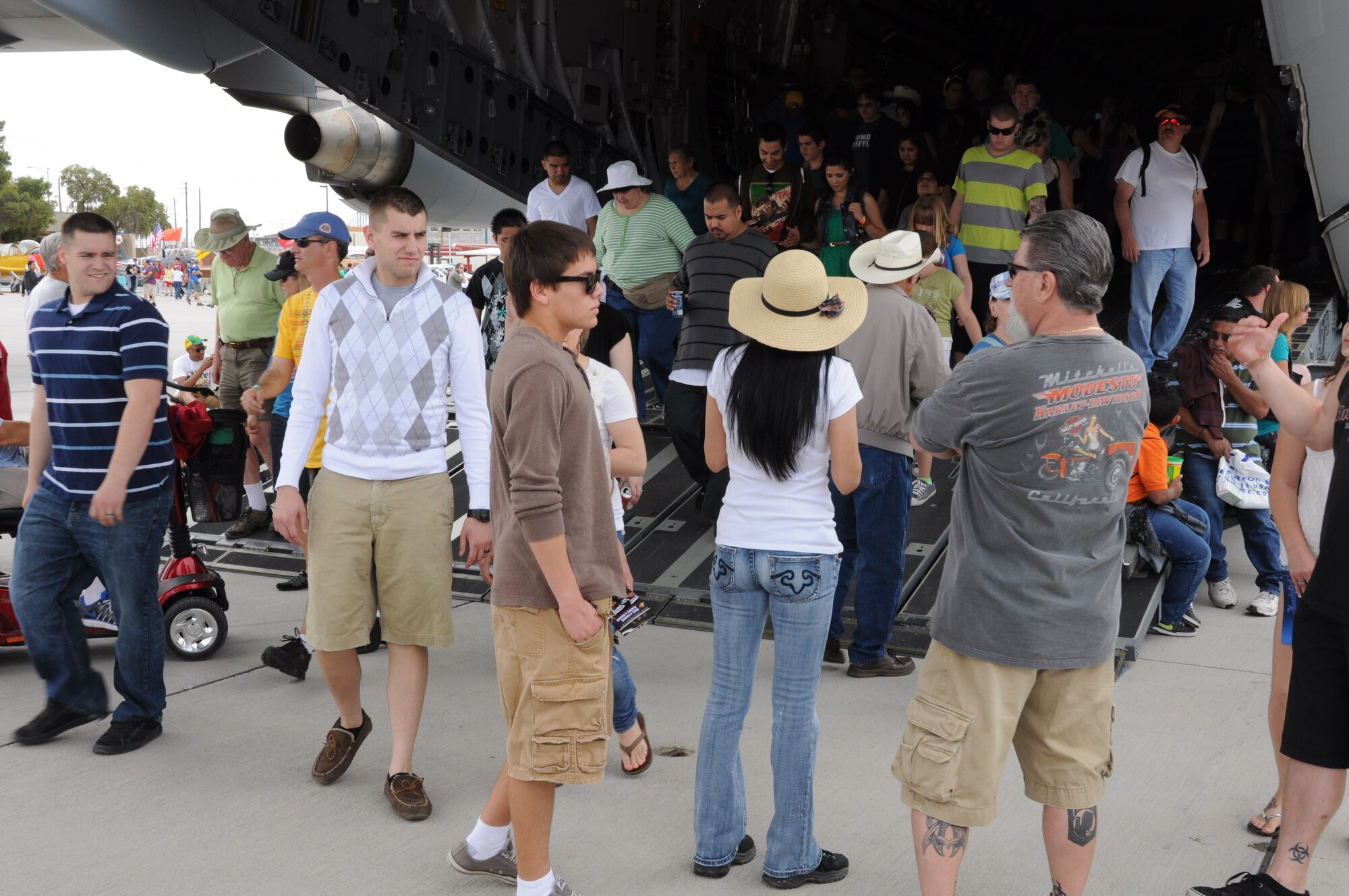 Marine Corps Air Station Yuma Airshow visitors exit the ramp of a C-17 Globemaster III aircraft from Joint Base Charleston, S.C. March 17, 2012. More than 60,000 visitors attended the MCAS Yuma Airshow, and the C-17 was a major attraction as it stood tall above all of the other aircraft. (U.S. Air Force photo/Staff Sgt. Shane Ellis)