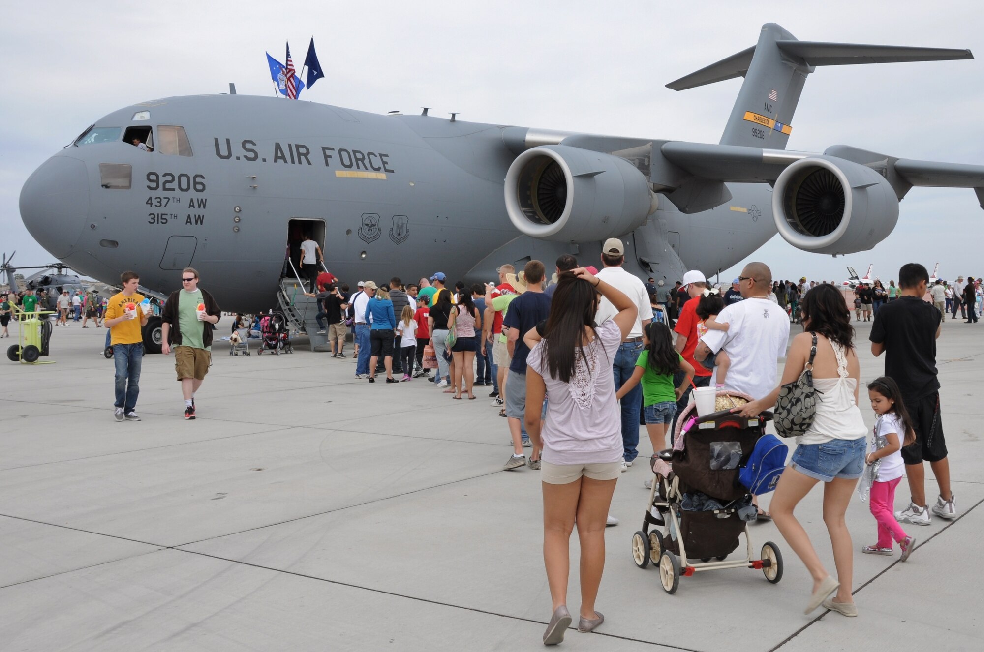 Marine Corps Air Station Yuma Airshow visitors wait in line for their opportunity to tour the inside of a C-17 Globemaster III aircraft from Joint Base Charleston, S.C. March 17, 2012. More than 60,000 visitors attended the MCAS Yuma Airshow, and the C-17 was a major attraction as it stood tall above all of the other aircraft. (U.S. Air Force photo/Staff Sgt. Shane Ellis)