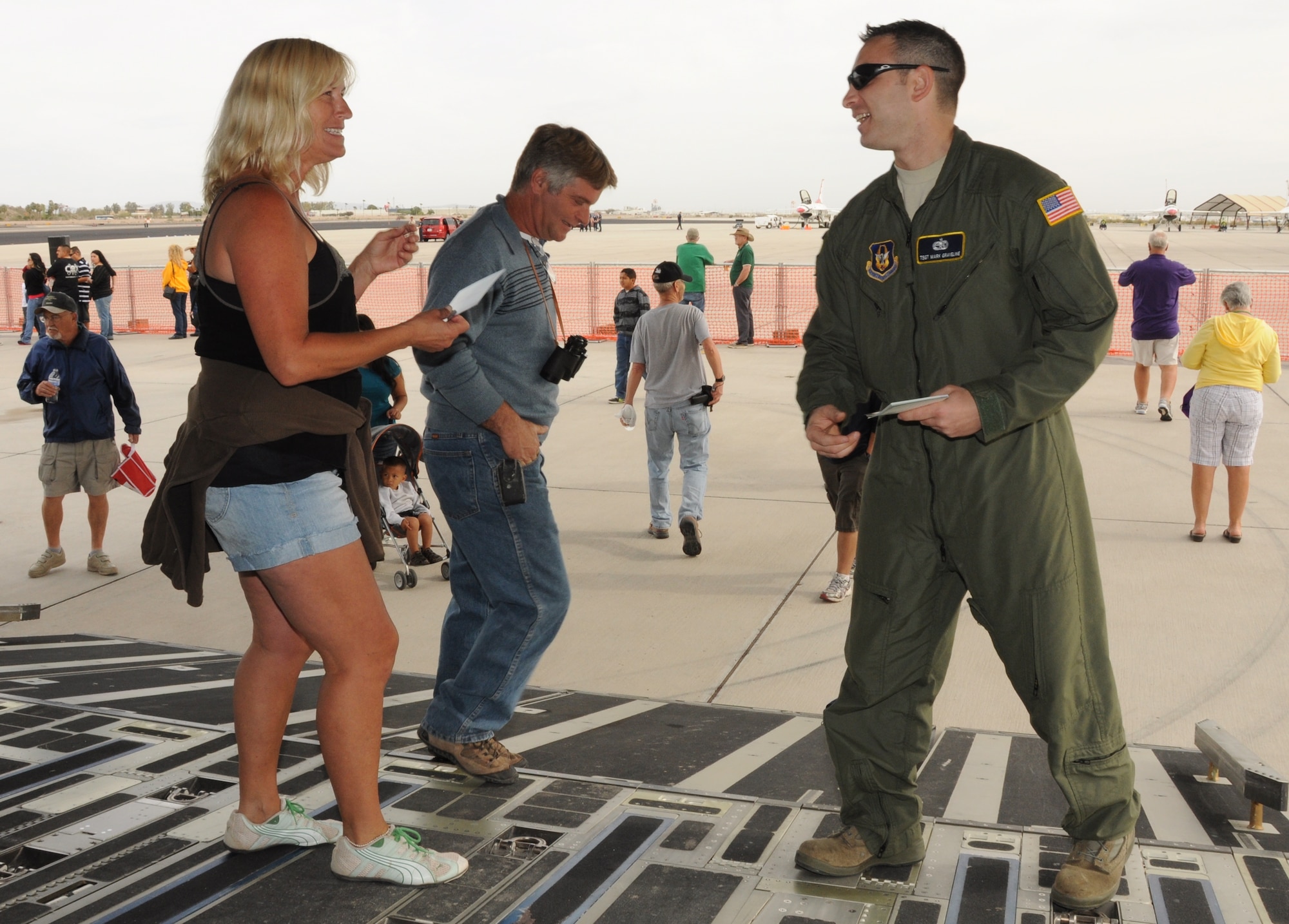 Tech. Sgt. Mark Graveline engages in some lively conversation during the Marine Corps Air Station Yuma Airshow March 17, 2012. During the airshow, Sergeant Graveline spent time educating airshow visitors about the aircraft, posing for photographs, signing autographs, and answering questions. More than 60,000 visitors attended the MCAS Yuma Airshow. Sergeant Graveline is a flying crew chief with the 315th Aircraft Maintenance Squadron at Joint Base Charleston, S.C.  (U.S. Air Force photo/Staff Sgt. Shane Ellis)