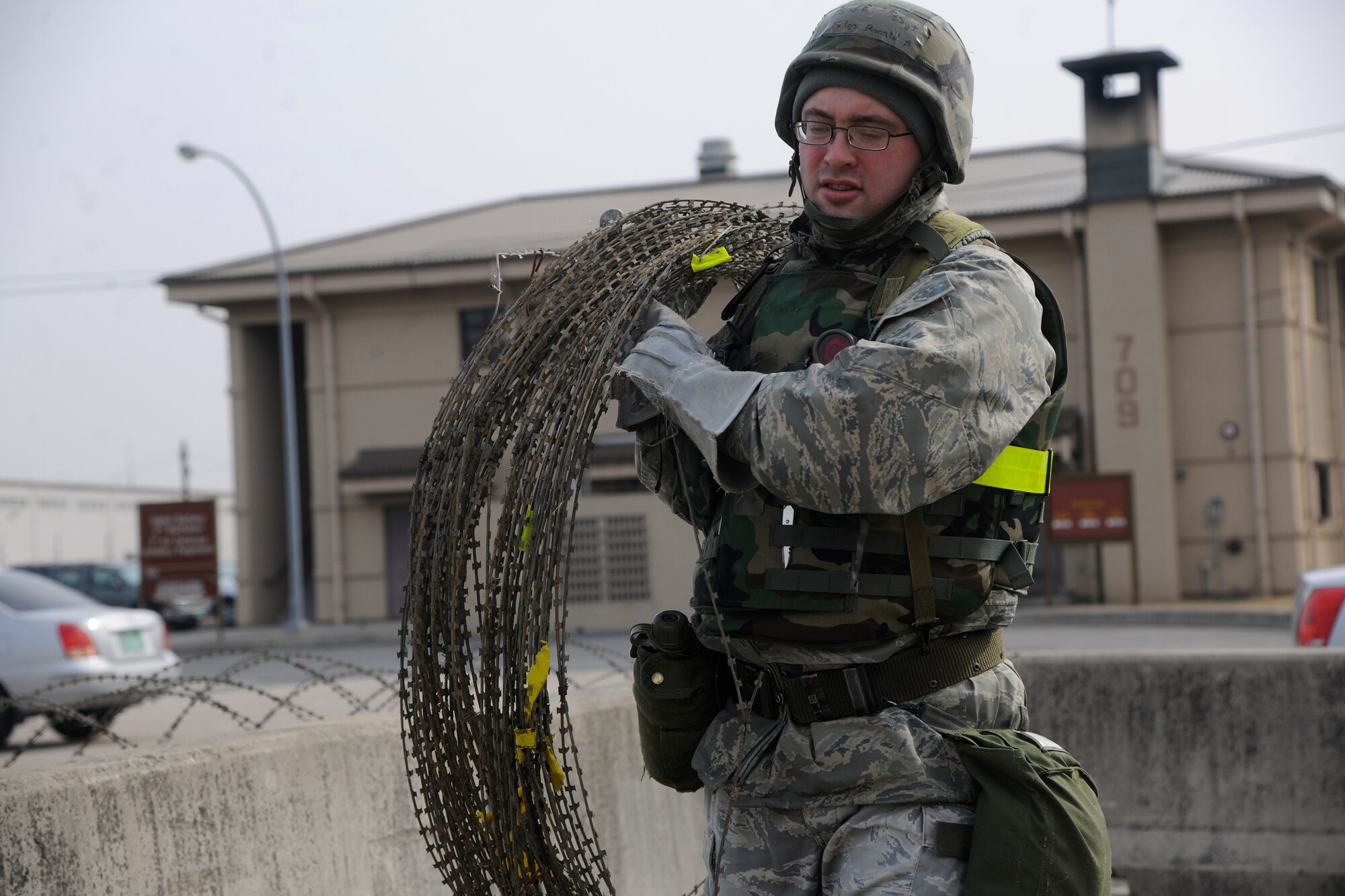 Staff Sgt. Ronald A. Klos, 8th Communications Squadron member, carefully carries concertina wire to be set up at perimeter during an operational readiness exercise at Kunsan Air Base, Republic of Korea, March 19, 2012. Wolf Pack Airmen, Soldiers and civilians have completed multiple rigorous exercises to prepare for the upcoming Combined Unit Inspection. (U.S. Air Force Photo by Staff Sgt. Rasheen Douglas/Released)