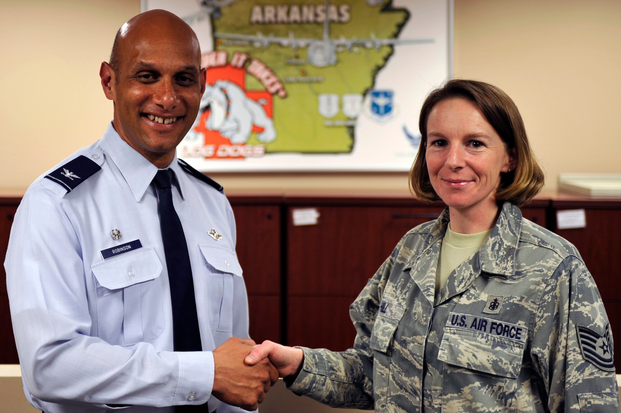 Col. Brian Robinson, 19th Airlift Wing commander, presents a commander’s coin to Tech. Sgt. Brandy Hill, a 19th Medical Support Squadron medical logistics flight chief March 19, 2012, at Little Rock Air Force Base, Ark.  Hill, a Fort Walton Beach, Fla., native, excels in both knowledge of medical logistics operations and execution of the mission. (U.S. Air Force photo by Airman 1st Class Rusty Frank)