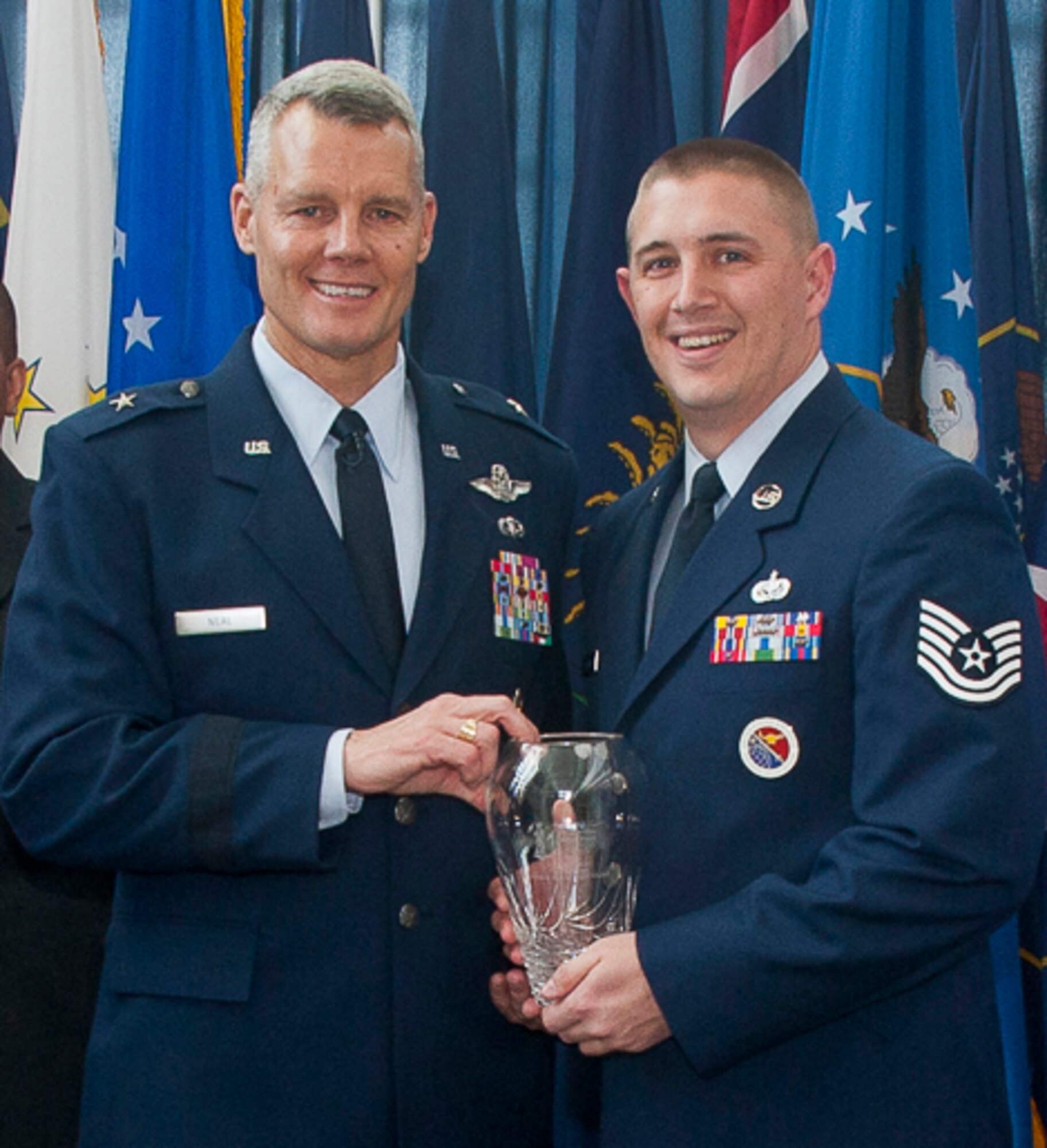 JOINT BASE ANDREWS, Md. - Tech. Sgt. Derek J. Westfall, right, an enlisted professional military education instructor at the I.G. Brown Training and Education Center, McGhee Tyson Air National Guard Base, Tenn., receives the 2011 Air National Guard Readiness Center NCO of the Year award from Brig. Gen. Brian G. Neal, ANGRC commander, during a ceremony held at Joint Base Andrews, Md., March 1, 2012. (Air National Guard photo by Master Sgt. Marvin Preston/Released)
