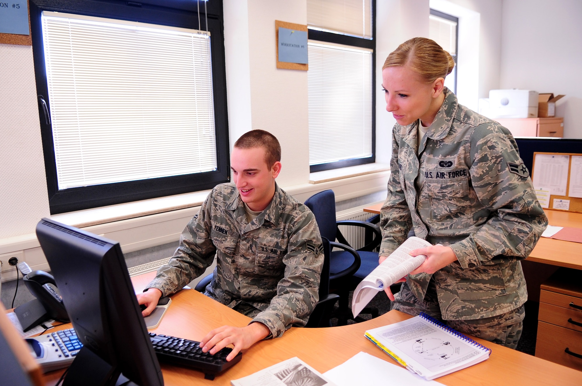Airman 1st Class Bonnie Shepard, 86th Airlift Wing, helps A1C Nicholas Fennen, 86th AW, with his taxes at the Law Center, Ramstein Air Base, Germany, March 20, 2012. Members at the Law Center strive to provide on-time, on-target legal advice and services to the Kaiserslautern Military Community. (U.S. Air Force photo by Senior Airman Brittany Perry)