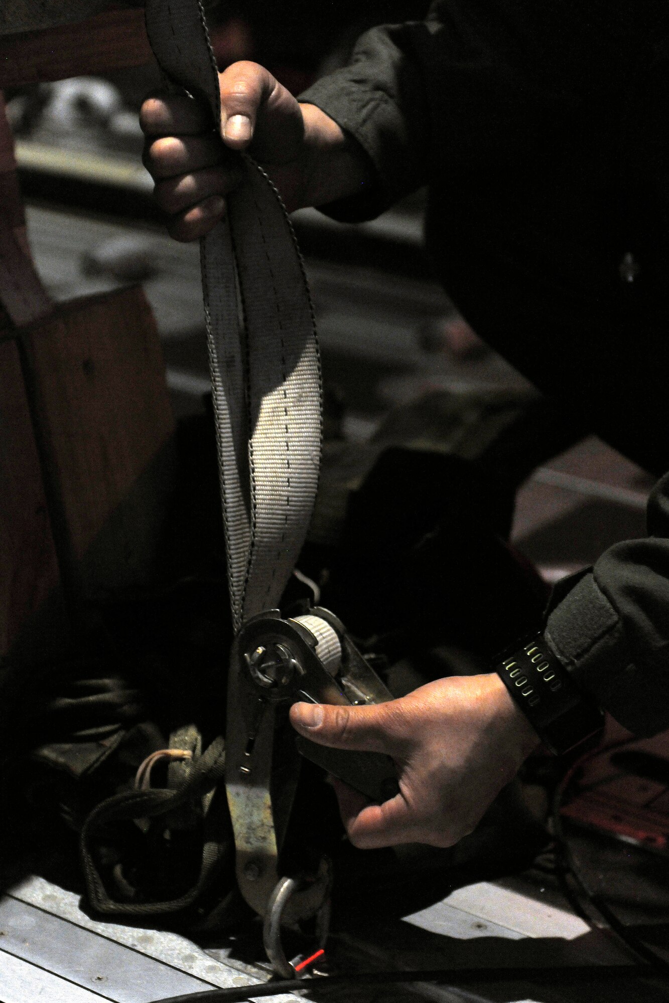 Tech. Sgt. Kepa Kahihikolo, 37th Airlift Squadron loadmaster, un-hooks the cargo straps in the cargo bay of a C-130J, March 16, 2012 at Ramstein Air Base, Germany.  The cargo was dropped in order to support field-training exercises for the 173rd Airborne Brigade Combat Team from Vicenza, Italy. This training gave pilots and loadmasters here an opportunity to practice this type of airdrop.  (U.S. Air Force photo/Staff Sgt. Chris Willis)