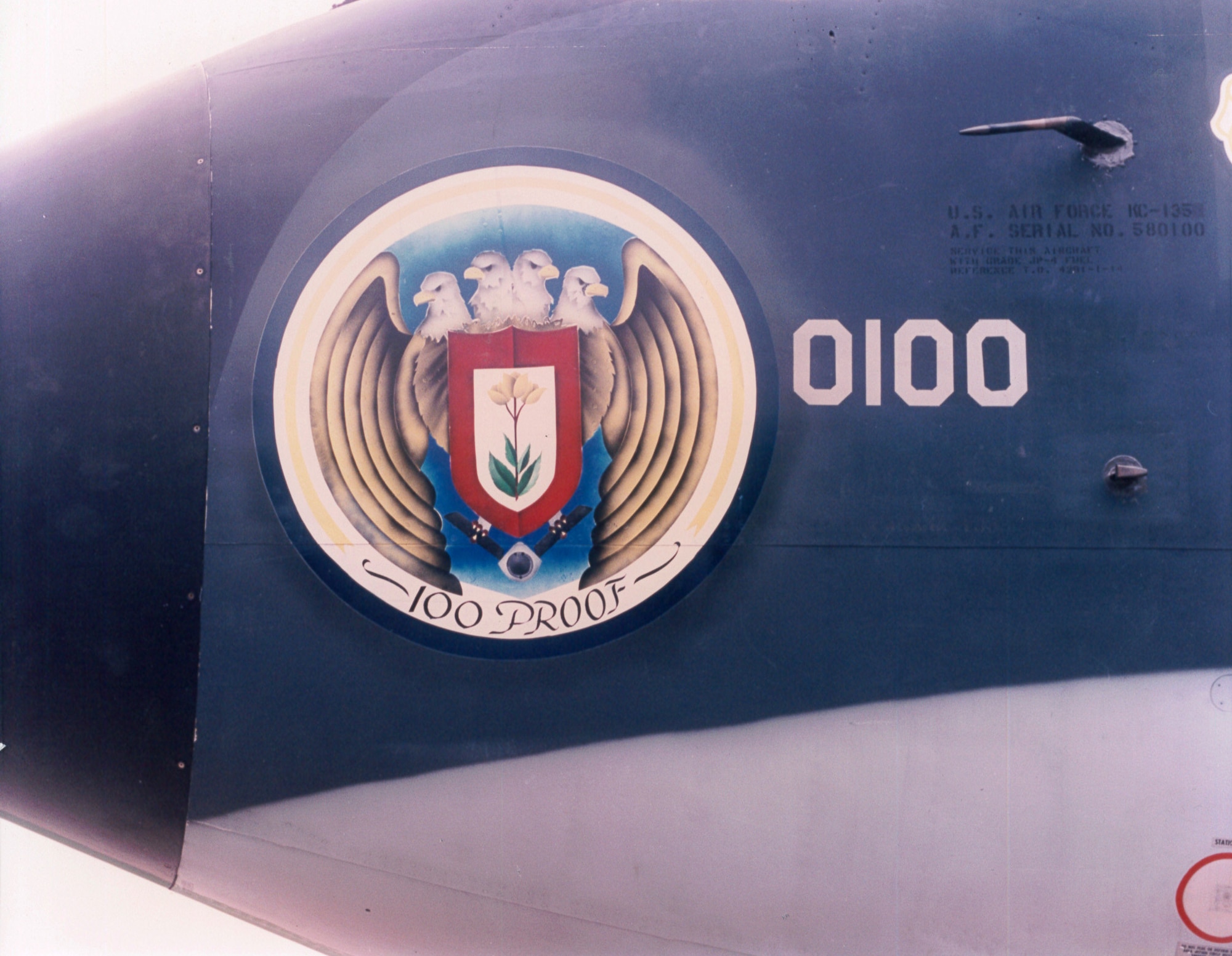 RAF MILDENHALL, England – A stylized version of the official 100th Bomb Group’s emblem dresses up the nose of KC-135 Stratotanker 58-0100 in the mid ’90s. The original emblem had bombs in the four-headed eagle’s talons, but in this instance they have been replaced by a KC-135 refueling boom to better reflect the wing’s current mission. The original, unedited emblem was placed back on the nose of tail number 0100 in a small ceremony March 14. The name “100 Proof” is being considered for reinstating as well. (File photo)