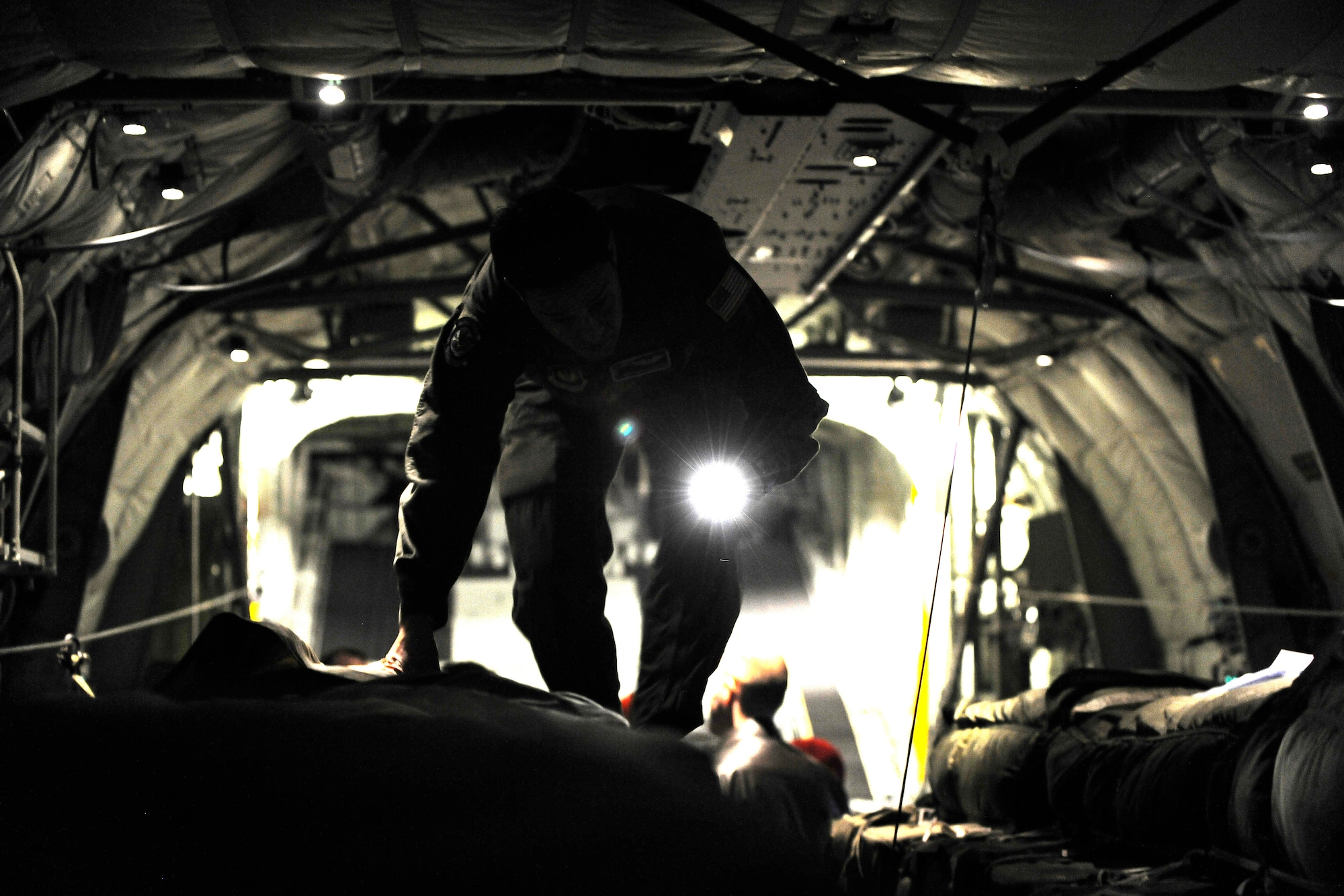 Tech. Sgt. Kepa Kahihikolo, 37th Airlift Squadron loadmaster, checks over the loaded ten-bundle container deployment system in the cargo bay of a C-130J, March 16, 2012 at Ramstein Air Base, Germany.  The cargo was dropped in order to support field-training exercises for the 173rd Airborne Brigade Combat Team from Vicenza, Italy. This training gave pilots and loadmasters here an opportunity to practice this type of airdrop.  (U.S. Air Force photo/Staff Sgt. Chris Willis)