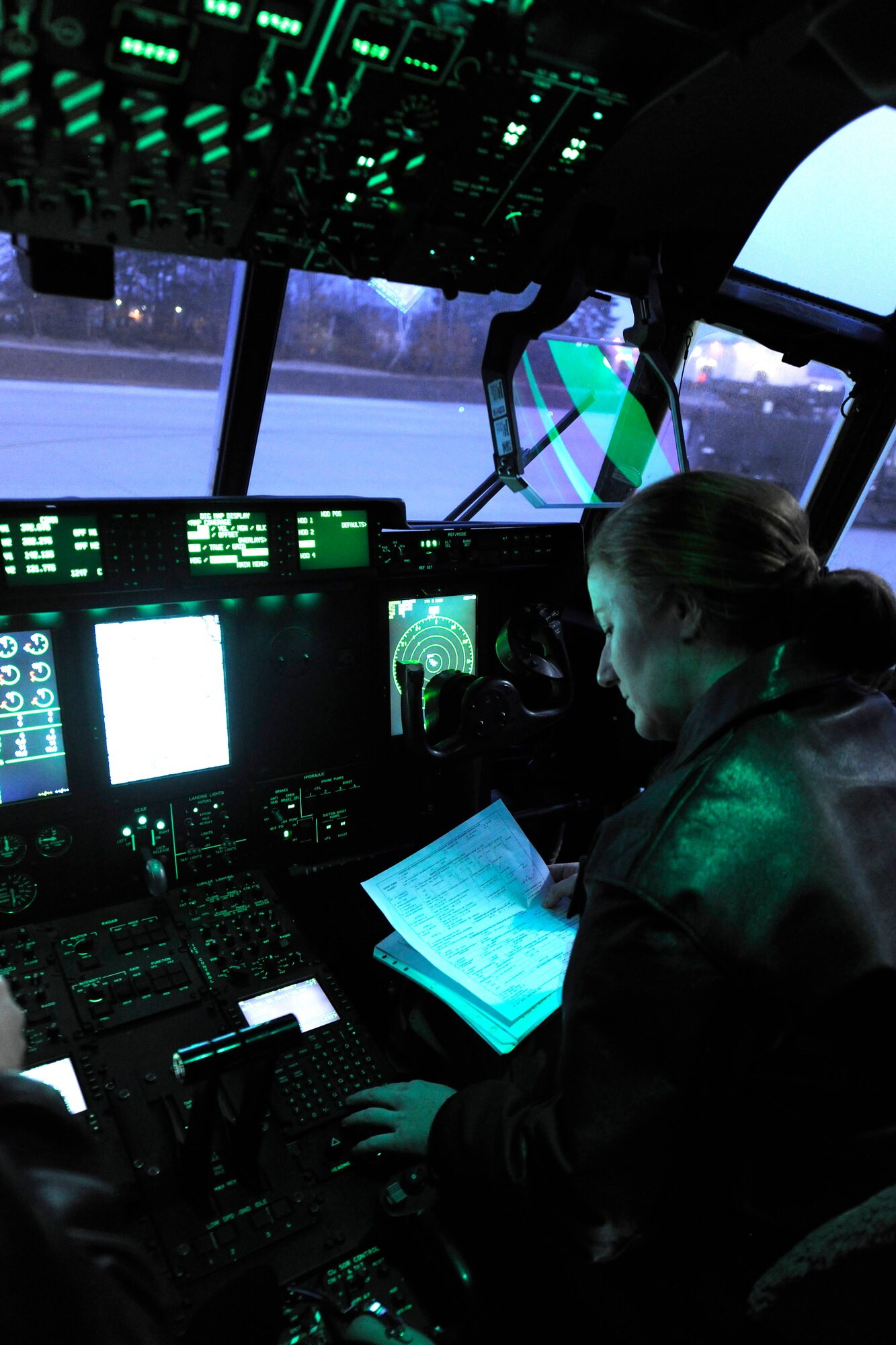 Capt. Marci Walton, 37th Airlift Squadron instructor pilot, goes through the pre-flight checklist in the flight deck of a C-130J, March 16, 2012, at Ramstein Air Base, Germany.  The 37th AS completed a week-long airdrop training exercise with a ten-bundle container deployment system at a drop zone near Grafenwoehr, Germany.  (U.S. Air Force photo/Staff Sgt. Chris Willis)