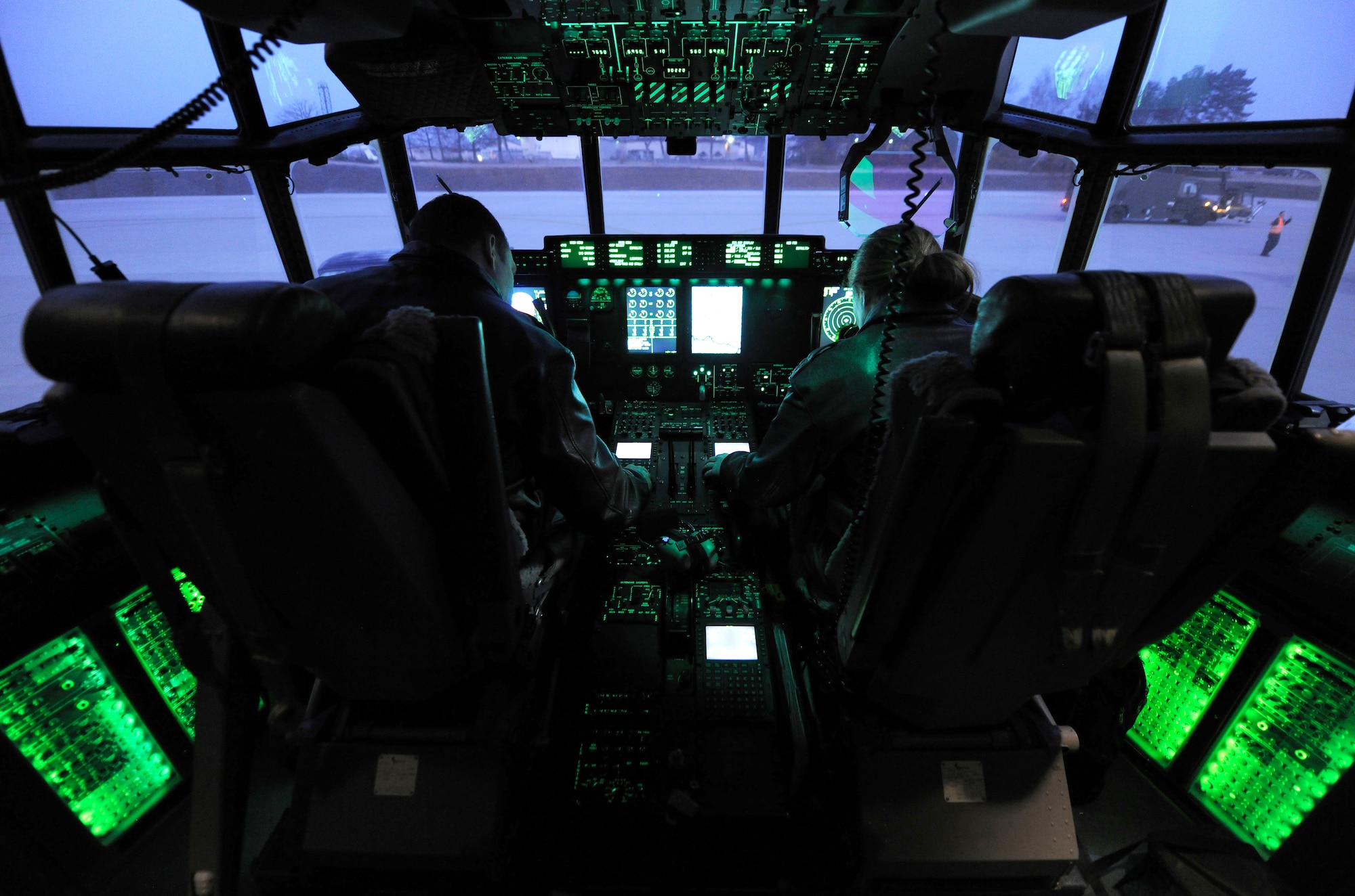 Lt. Col. Joshua Olson, 37th Airlift Squadron commander, and Capt. Marci Walton, 37th Airlift Squadron instructor pilot, go through the pre-flight checklist in the flight deck of a C-130J, March 16, 2012 at Ramstein Air Base, Germany.  The 37th AS completed a week-long airdrop training exercise with a 
ten-bundle container deployment system at a drop zone near Grafenwoehr, Germany.  (U.S. Air Force photo/Staff Sgt. Chris Willis)
