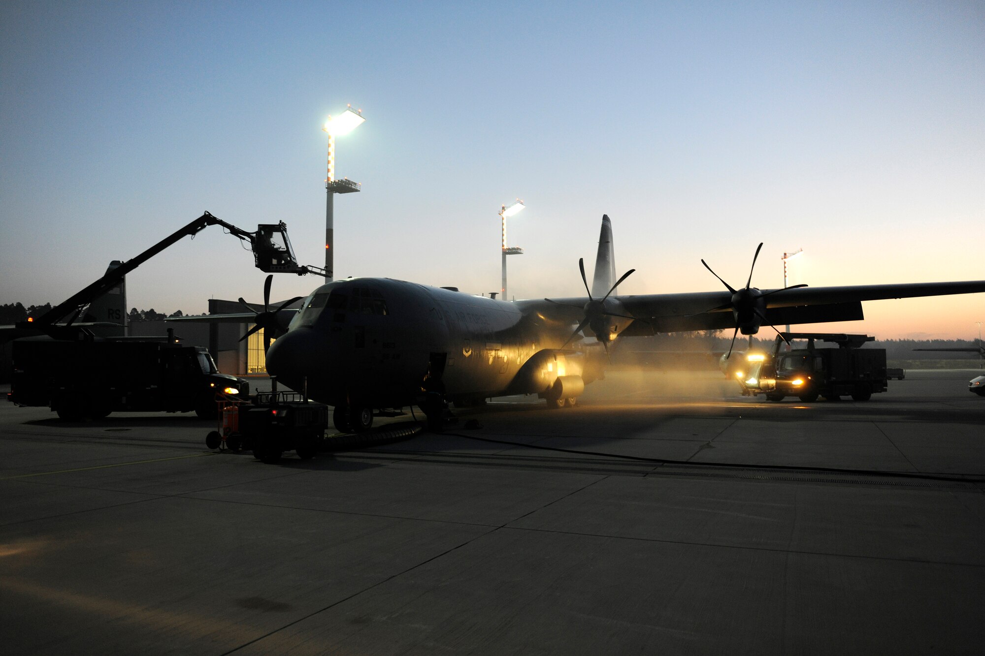 A C-130J receives a de-icing before the 37th Airlift Squadron completes a week-long training exercise with a ten-bundle container deployment system drop, March 16, 2012 at Ramstein Air Base, Germany.  The cargo was dropped in order to support field-training exercises for the 173rd Airborne Brigade Combat Team from Vicenza, Italy. This training gave pilots and loadmasters here an opportunity to practice this type of airdrop.  (U.S. Air Force photo/Staff Sgt. Chris Willis)