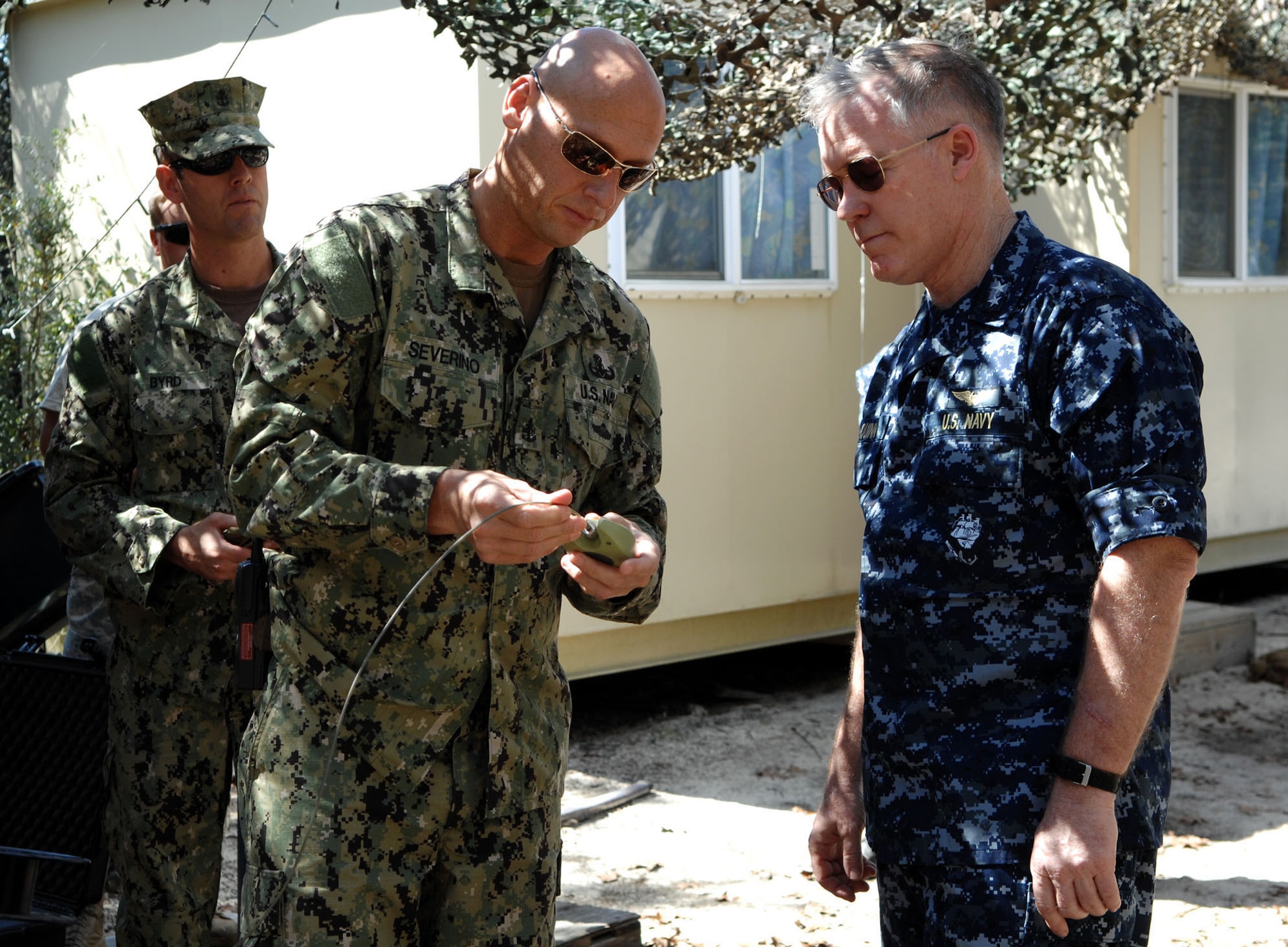 Rear Adm. Donald Quinn, the commander of Naval Education and Training Command, observes Senior Chief Explosive Ordnance Disposal Technician Joseph Severino, an instructor at Naval School Explosive Ordnance Disposal, as he initiates shock tube during a tour of the improvised explosive device division, March 14.  NAVSCOLEOD, located on Eglin Air Force Base, Fla., provides high-risk, specialized, basic and advanced EOD training to over 2,200 U.S. and partner nation military and selected U.S. government personnel each year. (U.S. Navy photo/ Ensign Elizabeth Allen)
