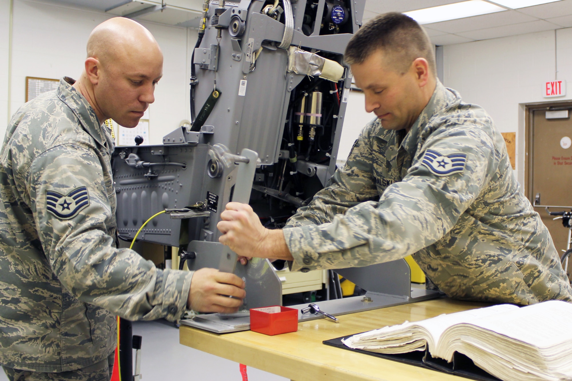 Staff Sgt. Jared Kowalski (right) and Staff Sgt. Nathan Henkel perform routine, scheduled maintenance on the ACES-II ejection seat system in their role as egress technicians for the 127th Maintenance Squadron at Selfridge Air National Guard Base, Mich. The seat is used on the A-10 Thunderbolt II aircraft, which may be eliminated from Selfridge under a pending Air Force budget proposal. (U.S. Air Force photo by TSgt. Dan Heaton)