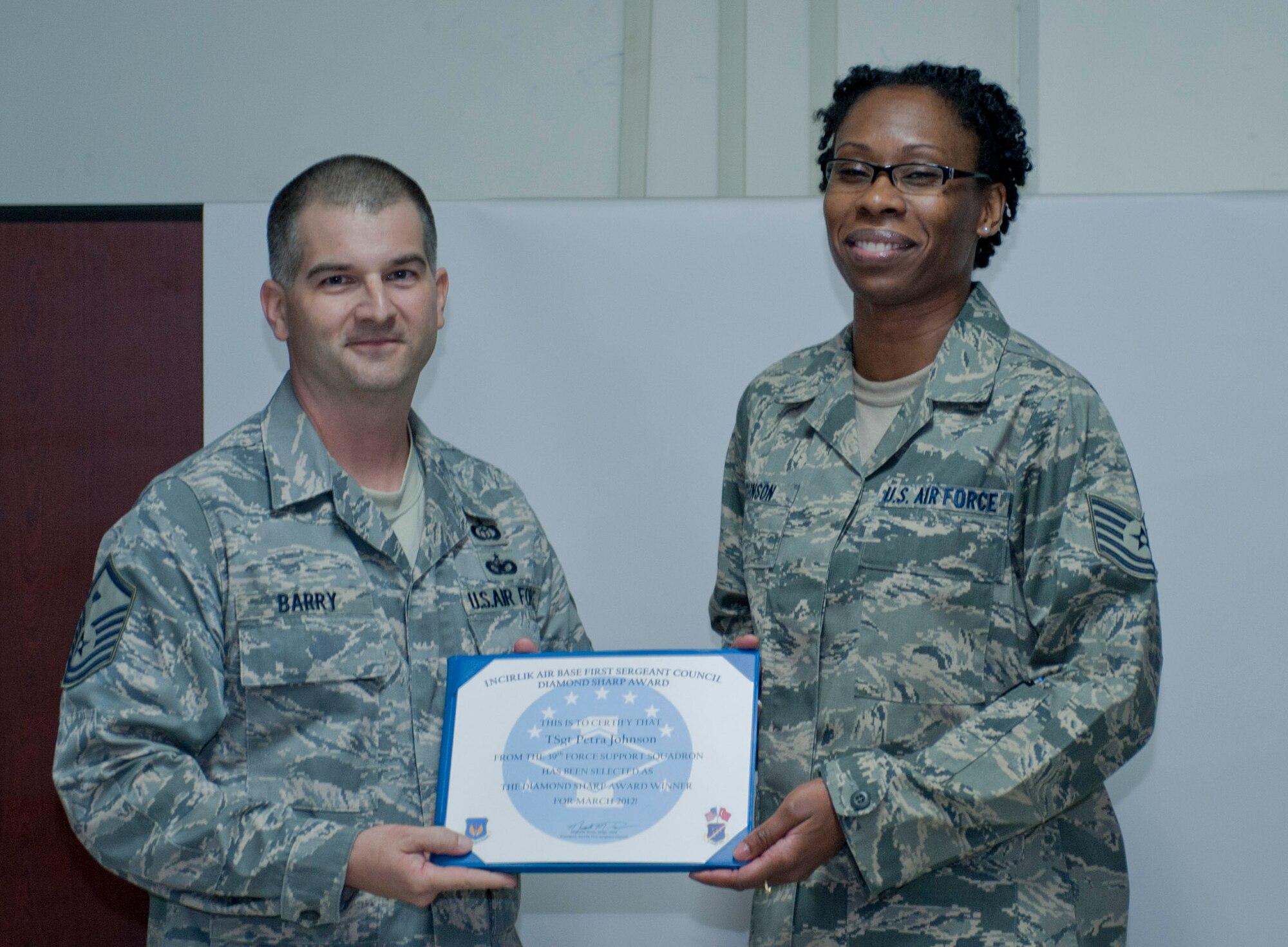 Tech. Sgt. Petra Johnson, 39th Force Support Squadron, right, is presented
the March 2012 Diamond Sharp Award by members of the Incirlik First Sergeant
Council March 7, 2012, at Incirlik Air Base, Turkey. Johnson earned the
monthly award by distinguishing herself through outstanding professionalism,
performance and display of the Air Force core values. (U.S. Air Force photo
by Senior Airman Anthony Sanchelli/Released)

