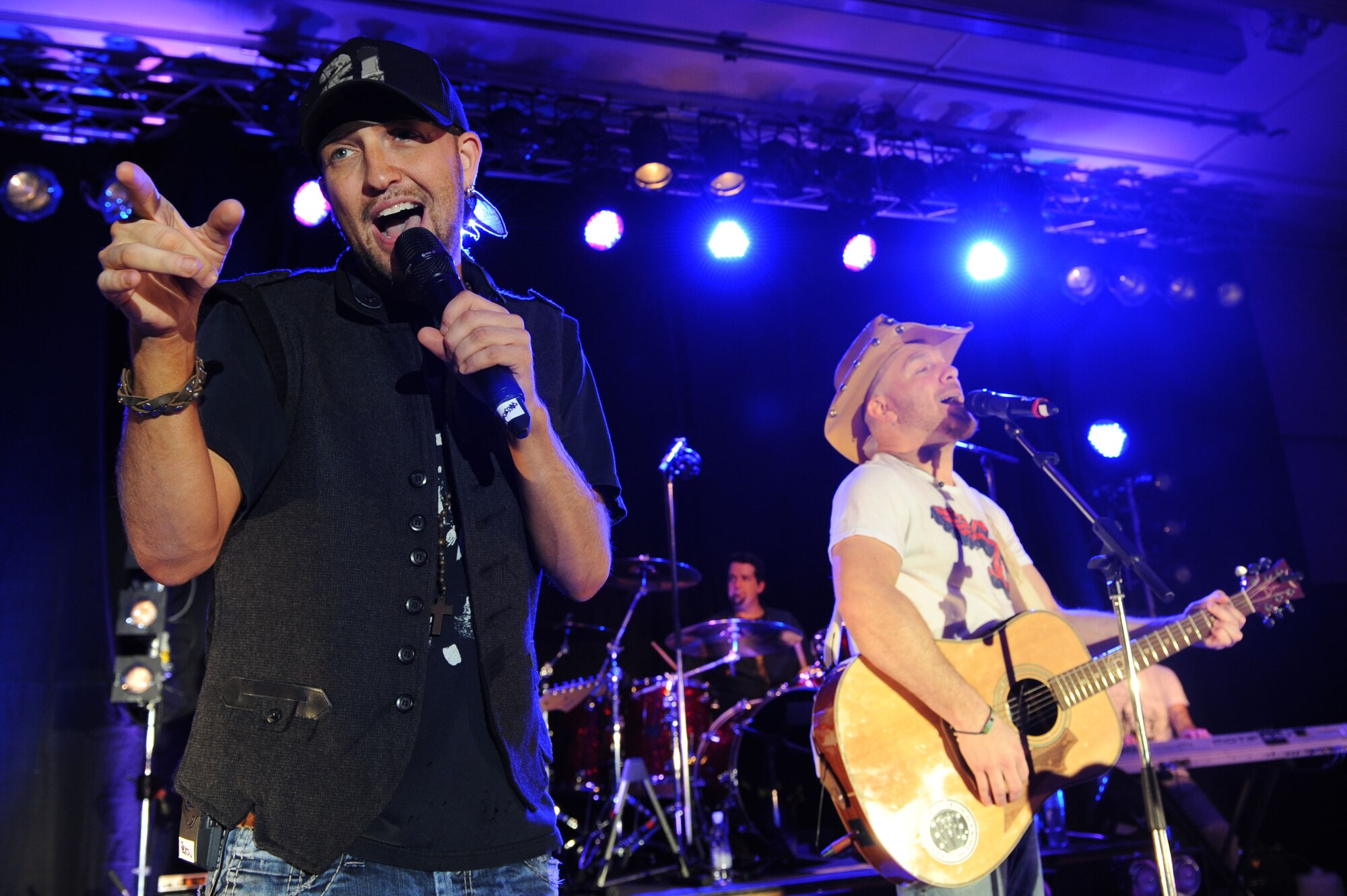 SPANGDAHLEM AIR BASE, Germany – Preston Brust (left) and Chris Lucas (right) perform during the LoCash Cowboys concert at the Brick House here March 18. The band played a variety of country and rock songs at six military installations in Germany to include Spangdahlem AB. The tour was sponsored by Stars for Stripes in partnership with Armed Forces Entertainment. Stars for Stripes is a non-profit organization designed to increase morale for overseas service members. (U.S. Air Force photo by Senior Airman Christopher Toon/Released)