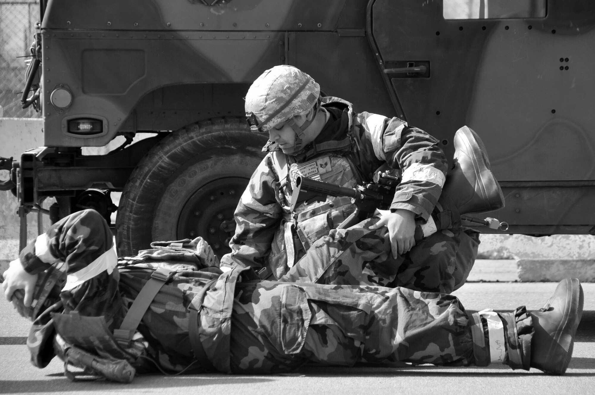 Staff Sgt. Jay Rivera, 51st Security Forces Squadron, provides self-aid and buddy care by elevating his wingman’s wounded leg, during operational readiness exercise Beverly Midnight 12-01, March 20, 2012. This scenario tested the readiness of Osan’s first responders as well as the 51st Fighter Wing’s abilities to work as a unit to accomplish the mission during the heightened state of readiness. (U.S. Air Force photo/Staff Sgt. Craig R. Cisek)