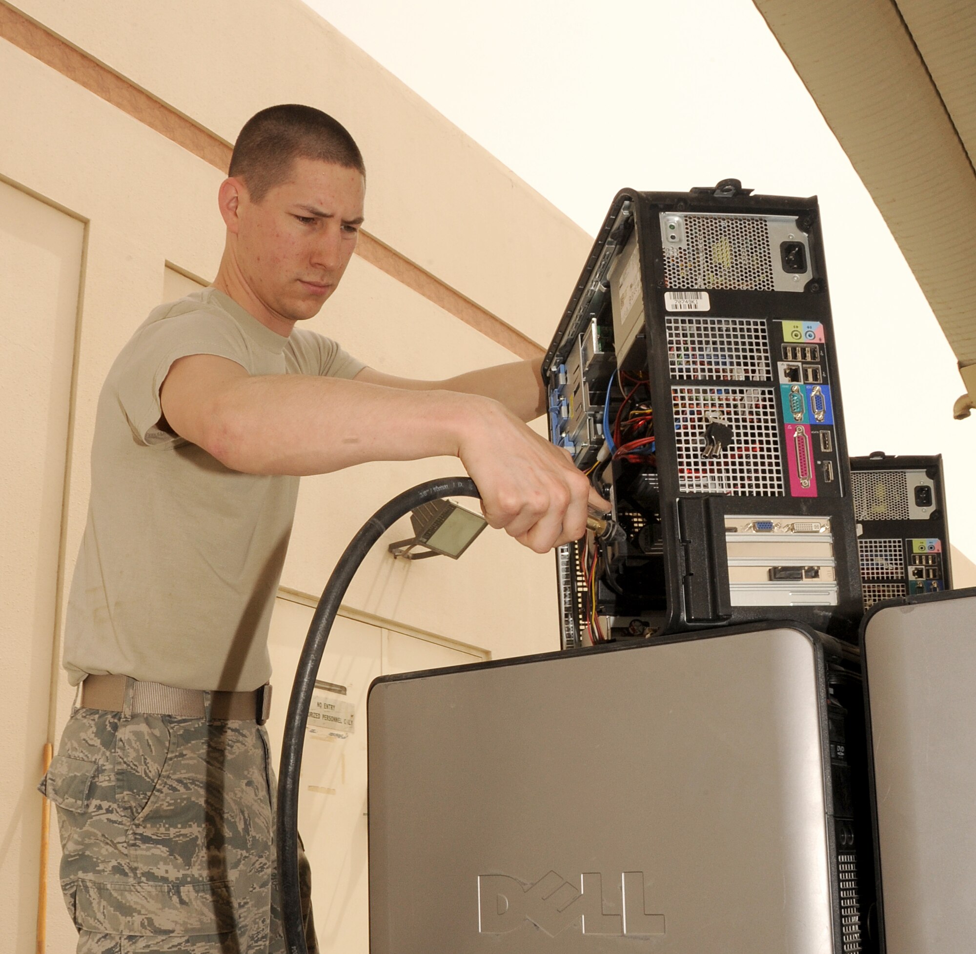 SOUTHWEST ASIA - Airman 1st Class Michael Dupre cleans computers with an air pressure machine March 19, 2012. To better support base communication needs, the 380th Expeditionary Communications Squadron ordered more than 200 used computers from bases that closed within the Air Forces Central area of responsibility. Before being issued, they were cleaned and checked to be in compliance with the wing?s network standards. Dupre is assigned to the 380th ECS and is deployed from Kadena Air Base, Japan. (U.S. Air Force photo/Tech. Sgt. Arian Nead)

