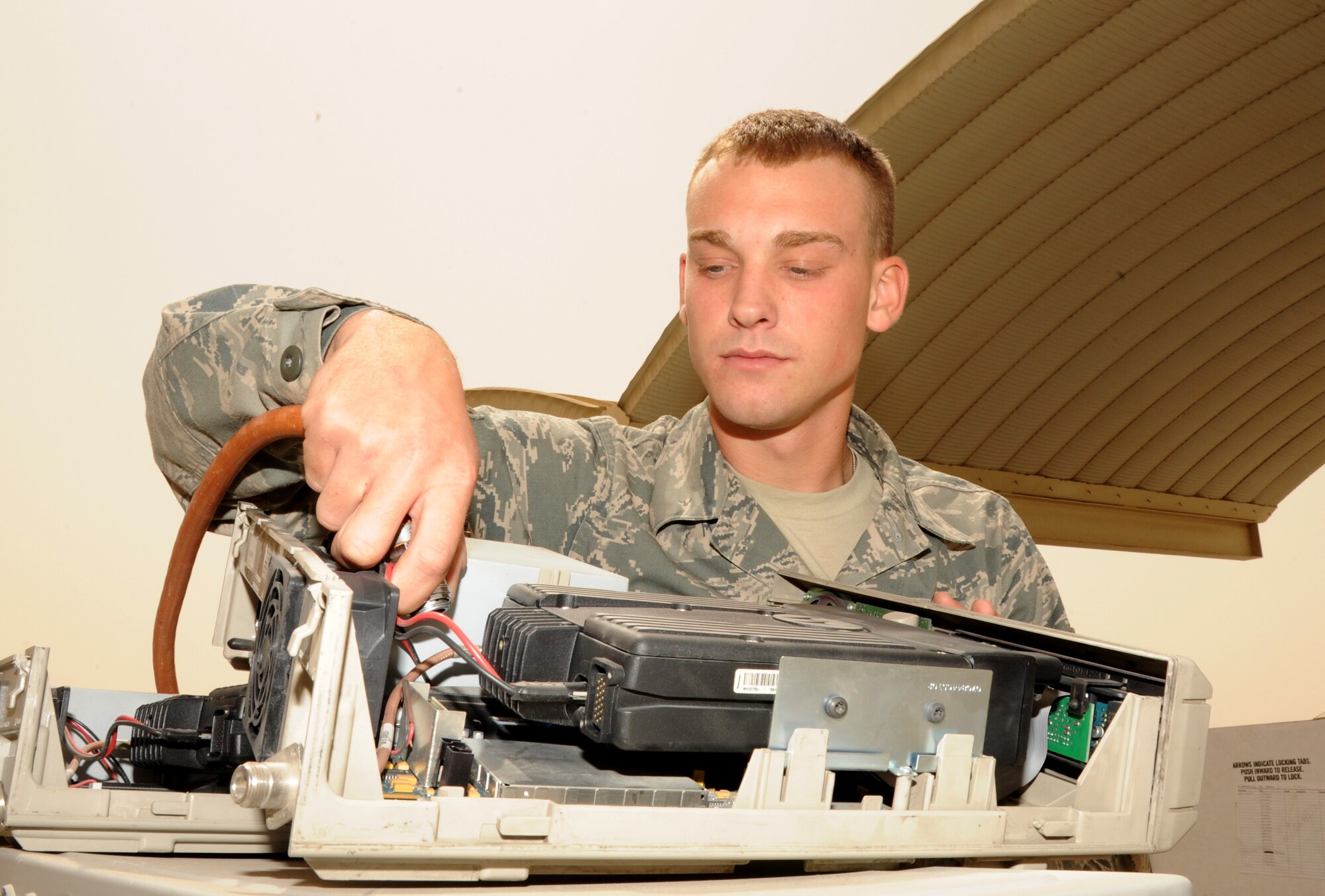 SOUTHWEST ASIA - Senior Airman Aaron Lawler cleans land mobile radio base stations March 19, 2012. To better support base communication needs, the 380th Expeditionary Communications Squadron ordered more than 200 used computers and electronic equipment from bases that closed within the Air Forces Central area of responsibility. Before being issued, they were cleaned and checked to be in compliance with the wing?s network standards. Lawler is assigned to the 380th ECS and is deployed from the 183rd Fighter Wing, Springfield, Ill. (U.S. Air Force photo/Tech. Sgt. Arian Nead)
