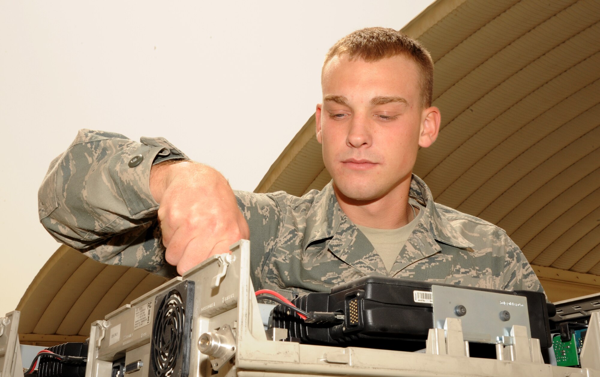 SOUTHWEST ASIA - Senior Airman Aaron Lawler cleans land mobile radio base stations March 19, 2012. To better support base communication needs, the 380th Expeditionary Communications Squadron ordered more than 200 used computers and electronic equipment from bases that closed within the Air Forces Central area of responsibility. Before being issued, they were cleaned and checked to be in compliance with the wing?s network standards. Lawler is assigned to the 380th ECS and is deployed from the 183rd Fighter Wing, Springfield, Ill. (U.S. Air Force photo/Tech. Sgt. Arian Nead)
