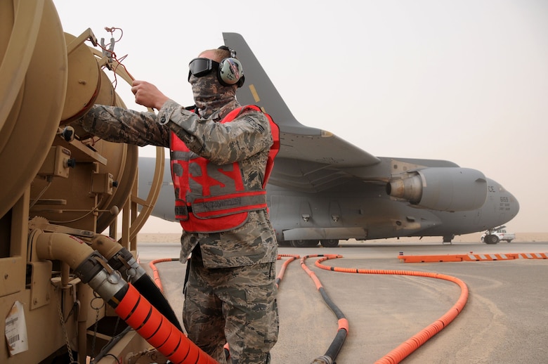 U.S. Air Force Senior Airman Ryan Brown, member of the 5th Expeditionary Air Mobility Squadron, disconnects bonding wire and removes fuel servicing equipment from a C-17 Globemaster at an undisclosed location in Southwest Asia, March 15, 2012. Brown and the 5th EAMS perform maintenance on C-17 Globemasters transiting in and out of U.S. Central Command?s area of responsibility. (U.S. Air Force photo by Staff Sgt. James Lieth/Released)