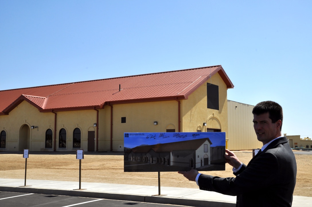 Michael Gearan, project manager, P&S Construction, Inc., displays the initial design rendering in front of the new indoor range facility. The U. S. Army Corps of Engineers Los Angeles District completed construction of the new indoor small-arms firing range and celebrated the milestone during a ribbon cutting ceremony here March 10.