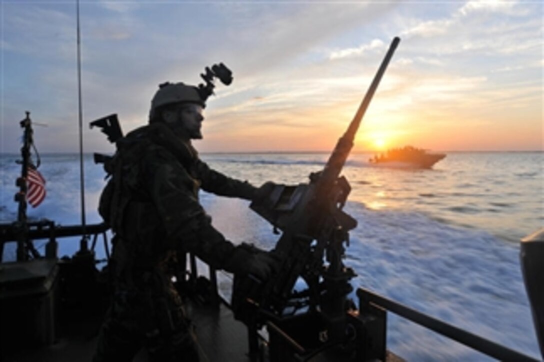 A U.S. Navy sailor assigned to Riverine Squadron 2 mans a .50-caliber machine gun aboard a Riverine Command Boat off the coast of Virginia during a live-fire exercise on March 13, 2012.  Riverine Squadron 2 is conducting unit level training in order to certify for upcoming deployments.  