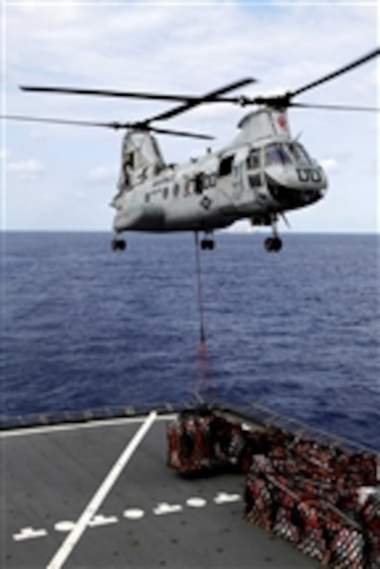 A CH-46E Sea Knight with Marine Medium Helicopter Squadron 265 (Reinforced), 31st Marine Expeditionary Unit, lifts cargo to deliver to the USS Essex (LHD 2) during a resupply at sea on March 13, 2012.  The ships are being resupplied at sea during the 31st Marine Expeditionary Unitís Certification Exercise, which upon completion certifies the 31st Marine Expeditionary Unit to respond to contingency missions throughout the Asia-Pacific region.  