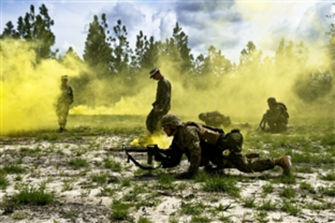U.S. Navy Seabees react to small arms fire during a training exercise on Camp Shelby, Miss., March 19, 2012. The exercise provides a robust training environment where Seabee forces plan and execute essential mission tasks before deployment. The Seabees are assigned to Naval Mobile Construction Battalion 74.