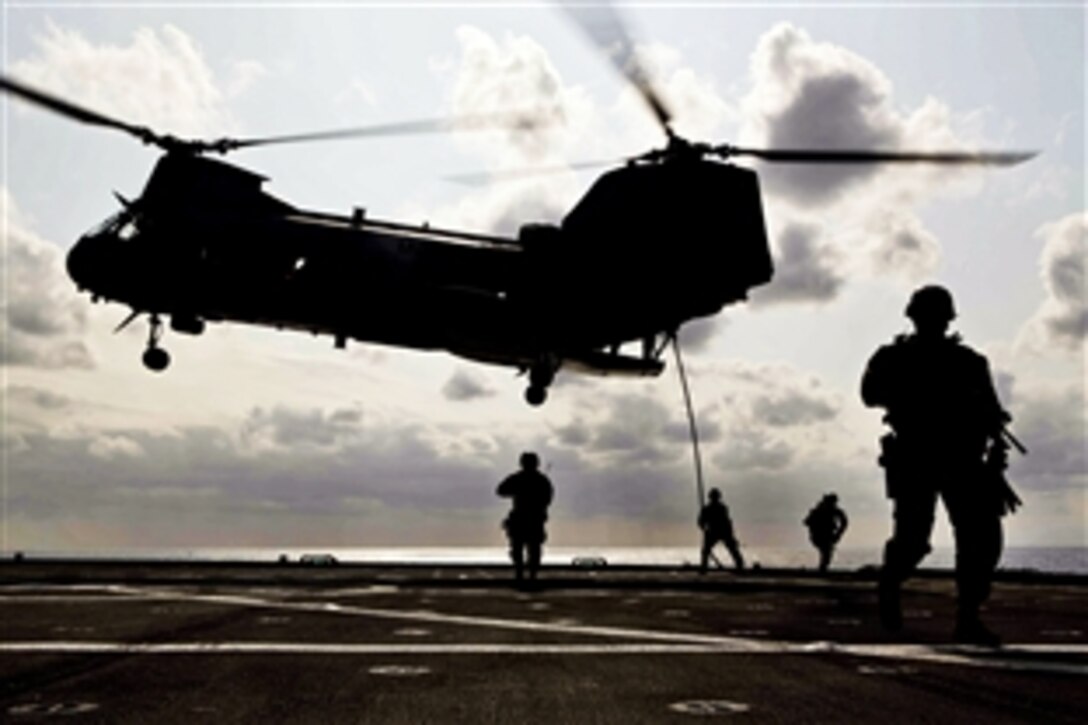 U.S. Marines fast rope from a CH-46E Sea Knight helicopter and secure the flight deck of the USNS Matthew C. Perry during a certification exercise off the coast of Okinawa, Japan, March 13, 2012. The Marines are assigned to the 31st Marine Expeditionary Unit, which is the only continuously forward-deployed Marine unit and the nation's force in readiness in the Asia-Pacific region.