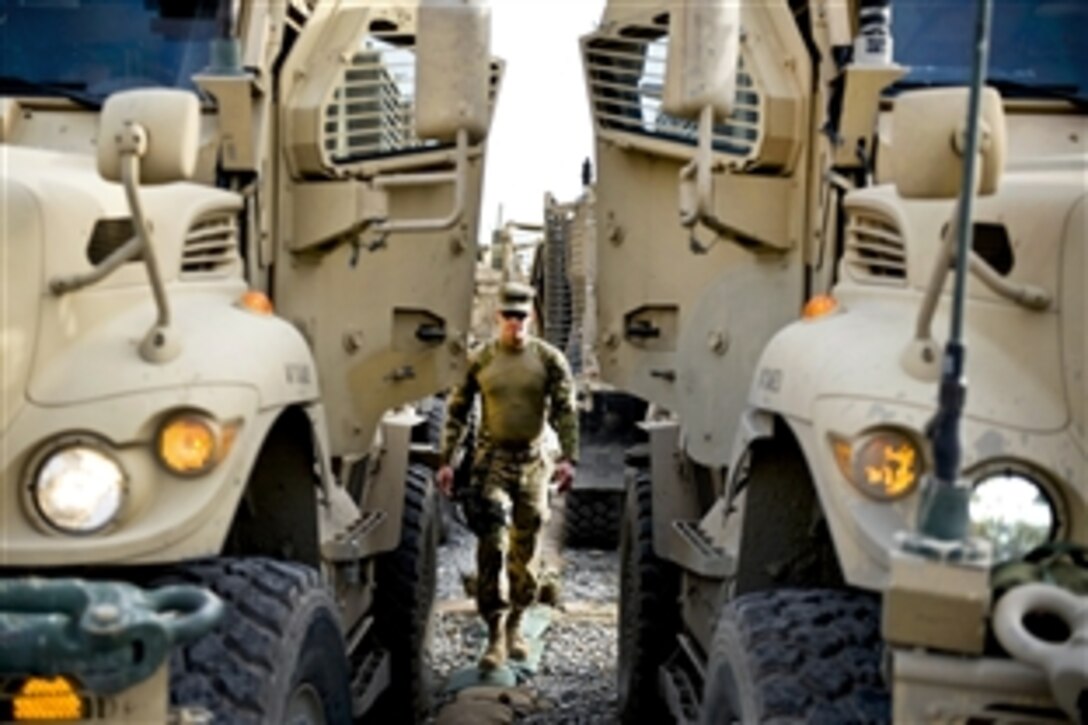U.S. Army Spc. Matthew Wright walks to prepare his truck for a mission outside the wire in Jalalabad City, Nangarhar province, Afghanistan, March 18, 2012. Matthew is assigned to the Nagarhar Agribusiness Development Team.