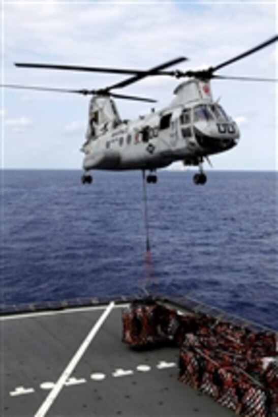 A CH-46E Sea Knight with Marine Medium Helicopter Squadron 265 (Reinforced), 31st Marine Expeditionary Unit, lifts cargo to deliver to the USS Essex (LHD 2) during a resupply at sea on March 13, 2012.  The ships are being resupplied at sea during the 31st Marine Expeditionary Unitís Certification Exercise, which upon completion certifies the 31st Marine Expeditionary Unit to respond to contingency missions throughout the Asia-Pacific region.  