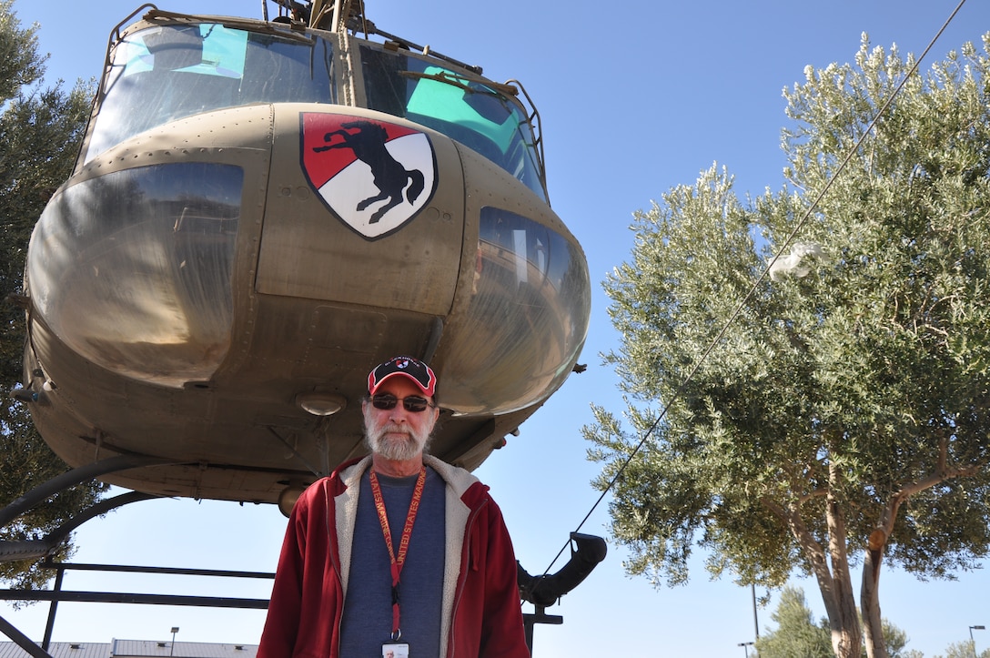 Curt Lambert, a photographer aboard Marine Corps Logistics Base Barstow, stands in front of a UH-1H Utility Helicopter, ::r::::n::the very one he flew during the Vietnam War as a chief warrant officer 2 in the Army. Lambert was reunited with his chopper after discovering it was placed at National Training Center Fort Irwin, 40 years after Vietnam.