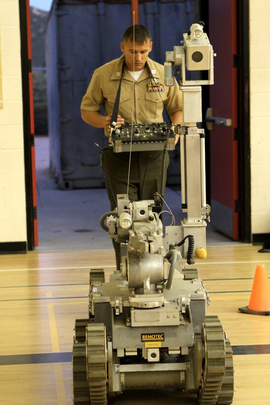 Capt. Erin Roush, the EOD officer in charge with Headquarters and Headquarters Squadron and a Denver native, controls the Mk 3 Mod. 0, a robot used to disable or relocate explosives during a robotics tournament at Bernardo Heights High School in San Diego, March 20. The Marines, based out of Marine Corps Air Station Miramar, Calif., presented three machines to students ranging from kindergarten to high schoolers taking part in the robotics program.
