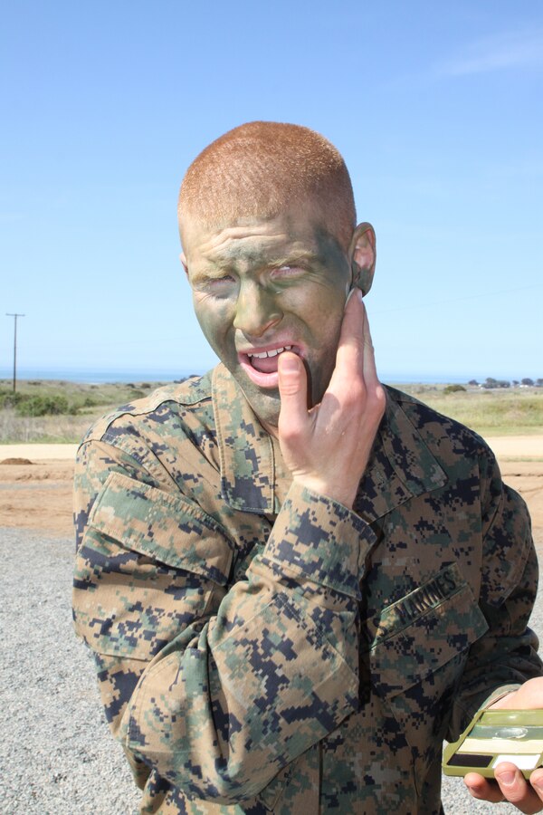 Recruit Colten C. Sponseller, platoon 2142, Company G, 2nd Recruit Training Battalion, applies camouflage paint to his face March 20 while on the crucible aboard Weapons and Field Training Battalion, Camp Pendleton. Sponseller, a Midland, Mich. native, came to recruit training hoping to gain experiences that would help guide him toward his dream of becoming a U.S. senator. He has enlisted in the United States Marine Corps Reserves for six years and plans to finish his international relations degree at Utah Valley University.