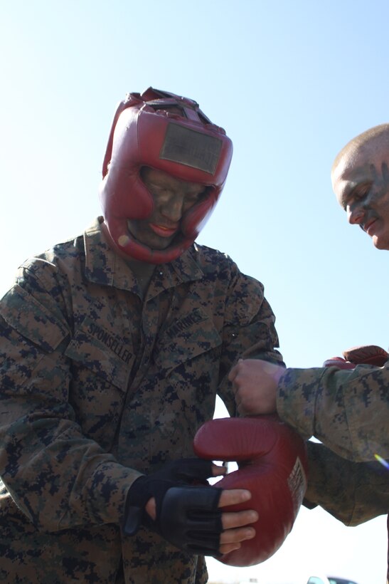 Recruit Colten C. Sponseller, platoon 2142, Company G, 2nd Recruit Training Battalion, puts on protective equipment to begin 'High Iams Drive' body sparring March 20 at Weapons and Field Training Battalion aboard Camp Pendleton. Sponseller joined the Marine Corps in hopes that this would be a stepping stone toward his dream of becoming a senator. He believes the Marine Corps can teach him things he wouldn't learn anywhere else.